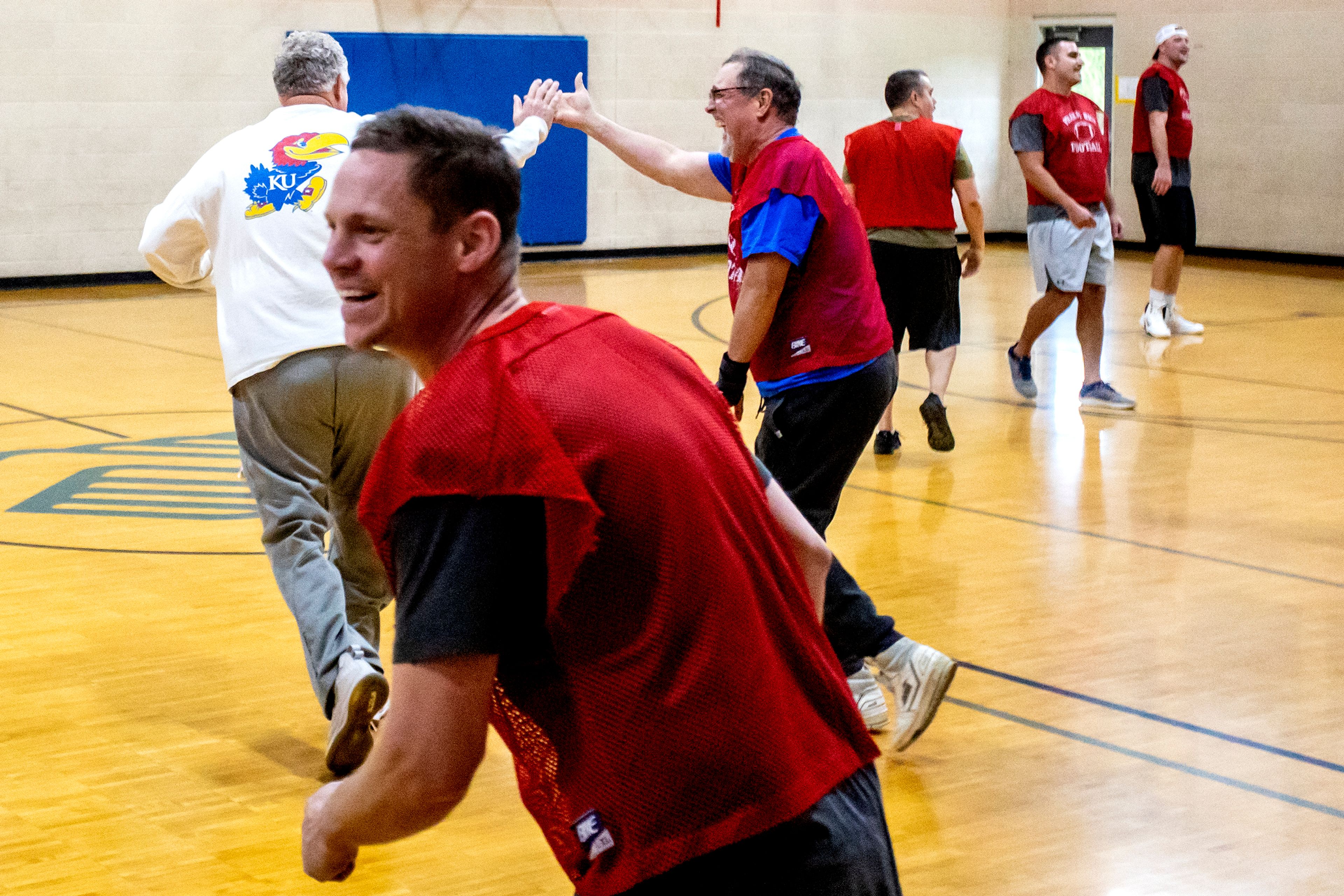 Steve Forge high fives Doug Blume as they run back across the court during Turkey Ball at the Lewiston Boys and Girls Club on Thursday. 