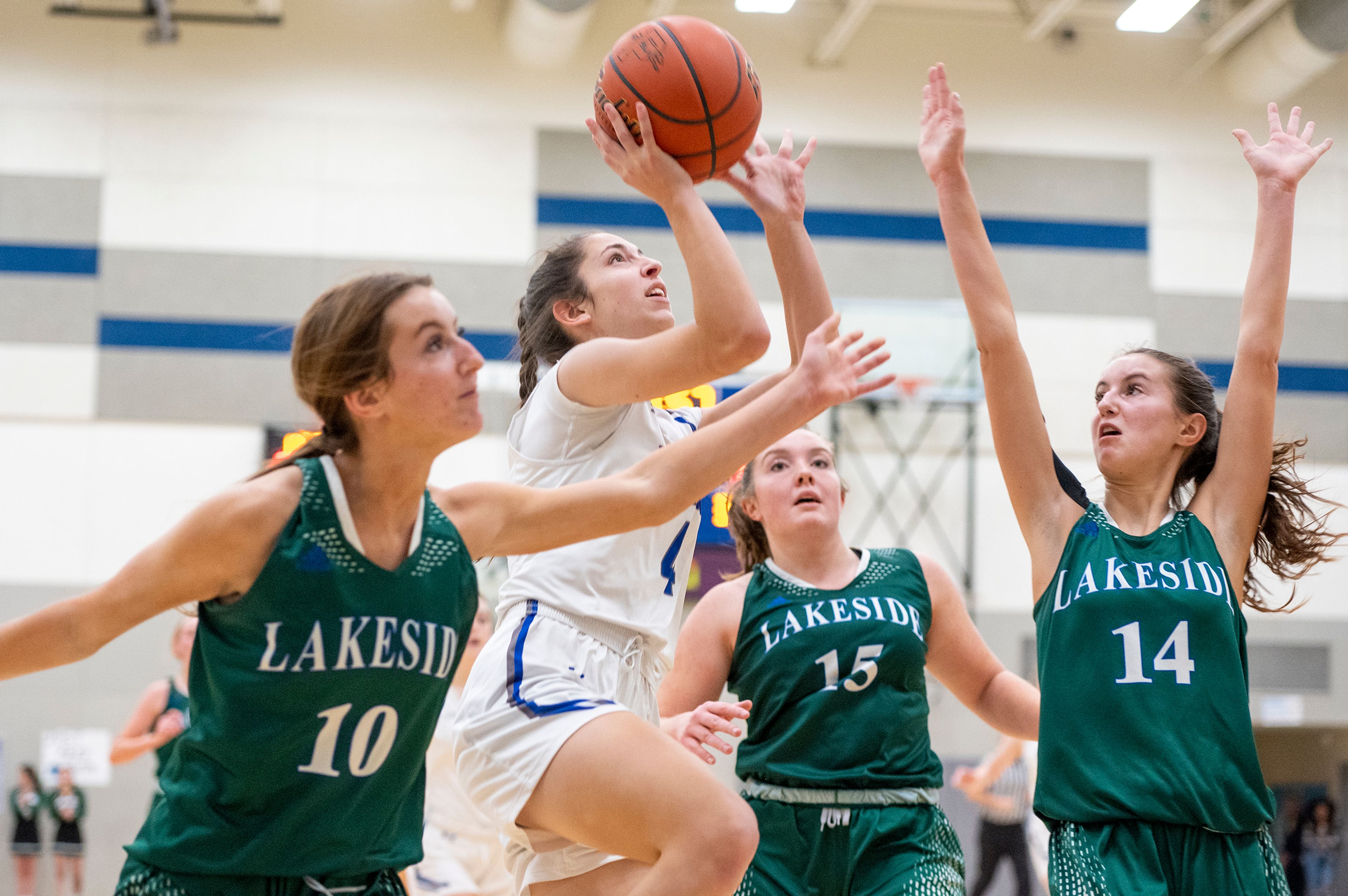 Pullman guard Jennabee Harris, center left, takes a shot over three Lakeside players during Friday's nonleague game.