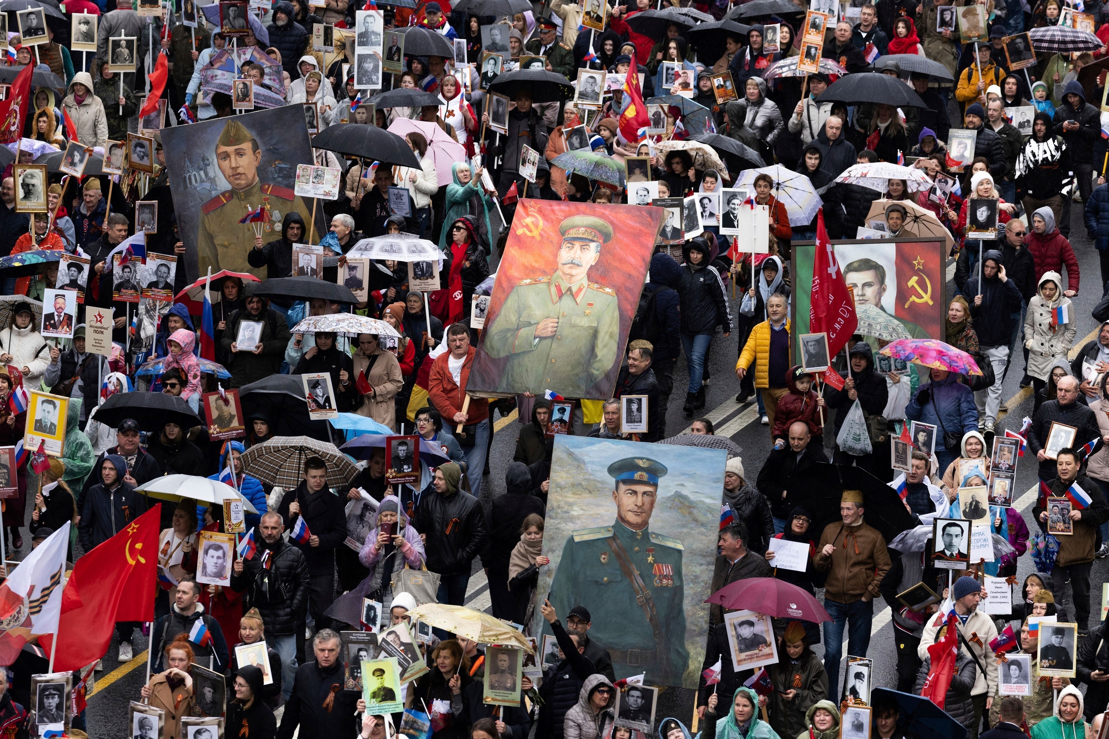 FILE - People attend the Immortal Regiment march through the main street toward Red Square marking the 77th anniversary of the end of World War II, in Moscow, Russia, Monday, May 9, 2022. In Russia, history has long become a propaganda tool used to advance the Kremlin's political goals. In an effort to rally people around the flag, the authorities have sought to magnify the country's past victories while glossing over the more sordid chapters of its history. (AP Photo/Denis Tyrin, File)