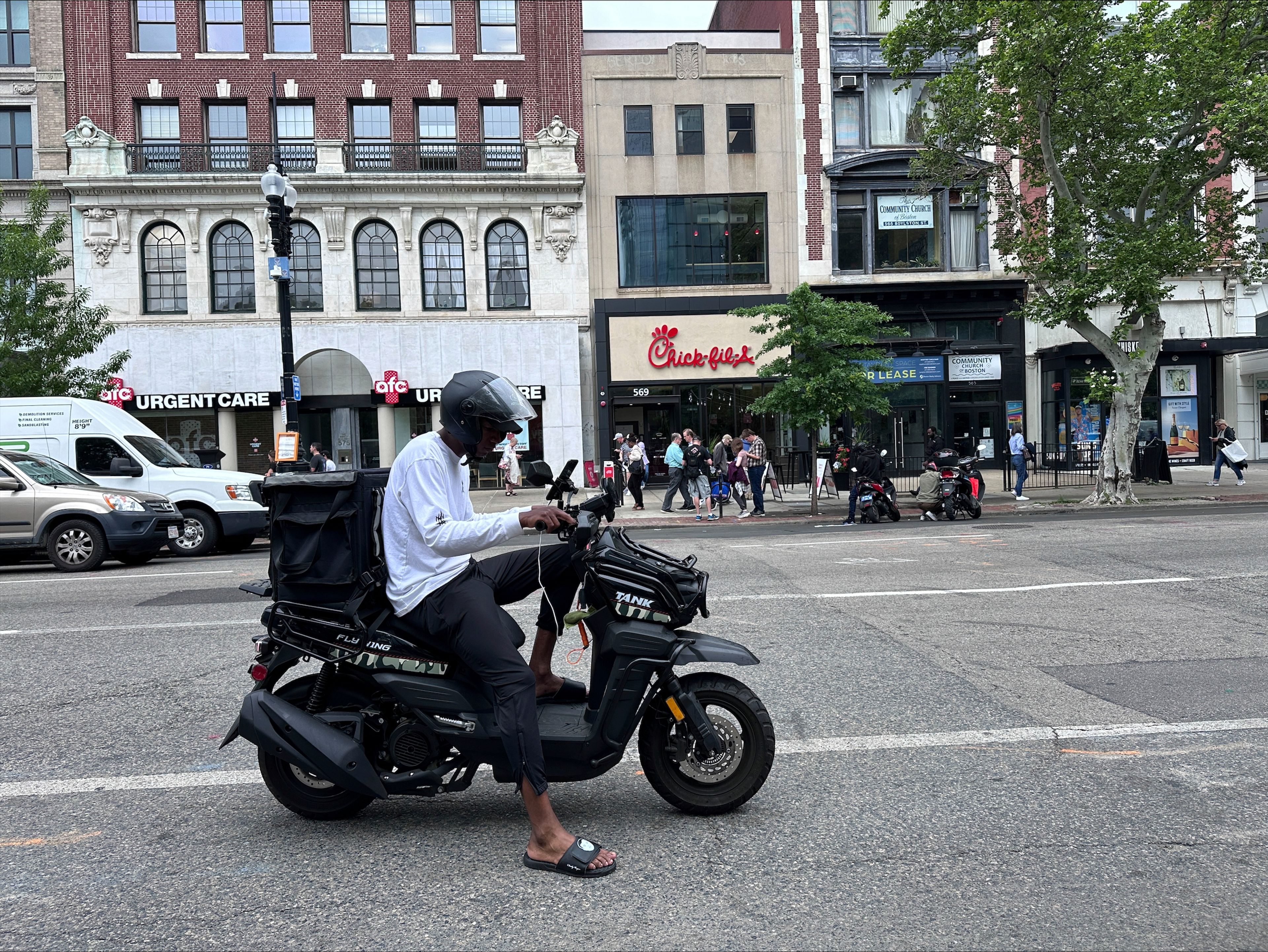 Delivery scooters are parked as drivers wait to pick up food for delivery, Thursday, June 6, 2024, in Boston. Boston and New York are cracking down on unlawful drivers, whom they say are ignoring traffic laws and making city streets more dangerous.