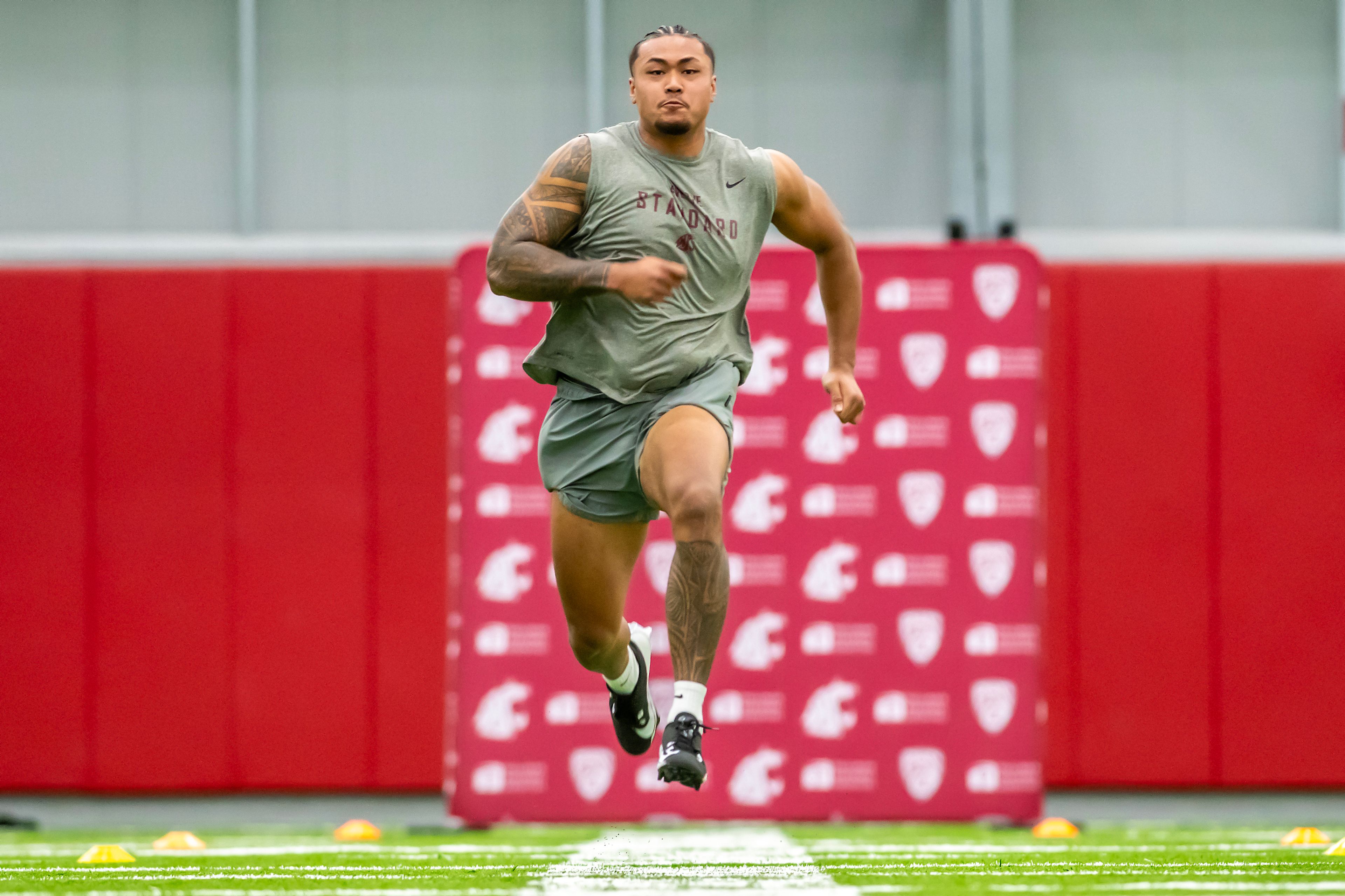 Washington State edge Nusi Malani runs the 40-yard dash during WSU's Pro Day on Friday in Pullman.