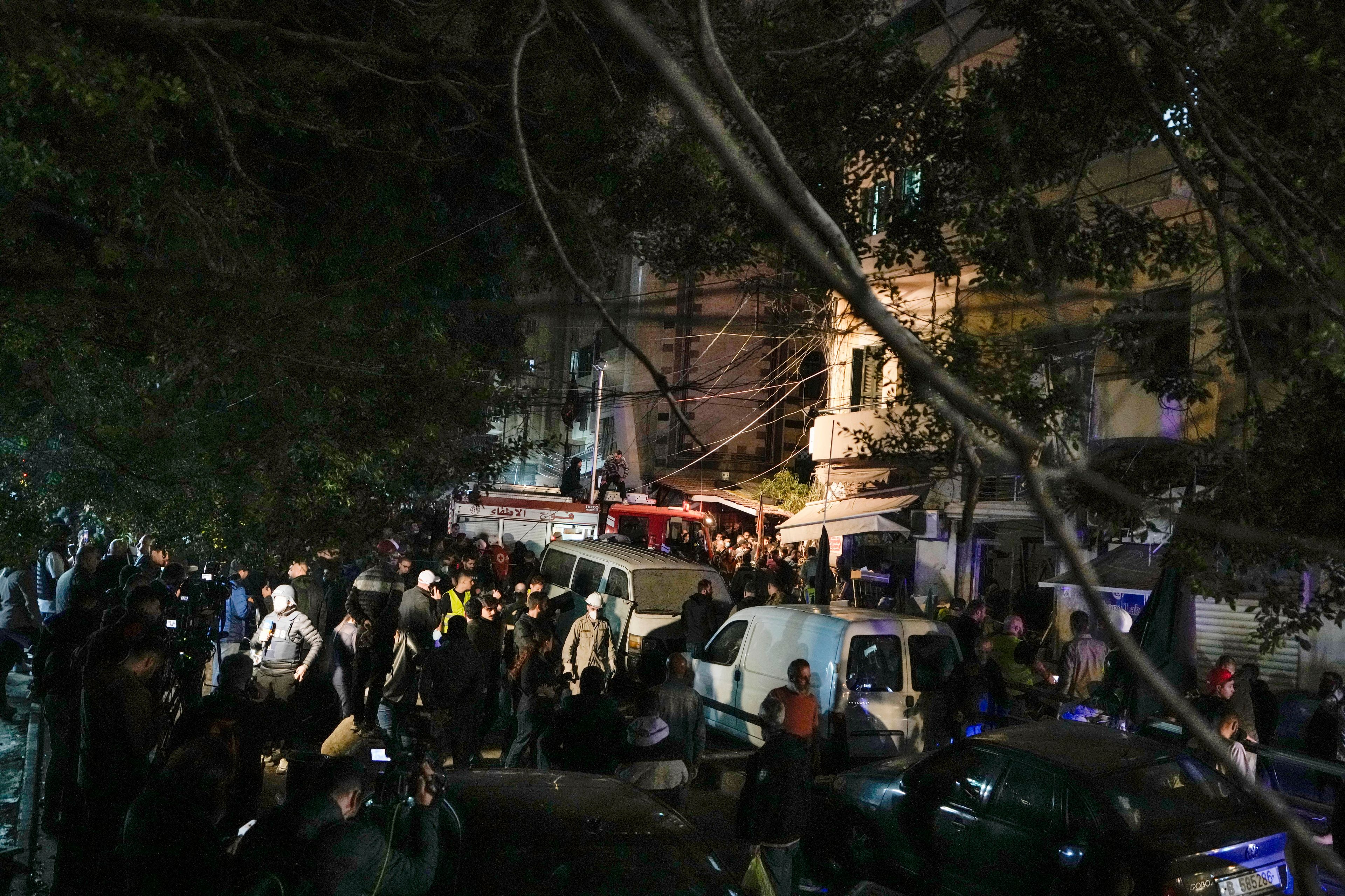 Residents and rescuers gather at the site of an Israeli airstrike in Beirut, Lebanon, Monday, Nov. 18, 2024. (AP Photo/Bilal Hussein)