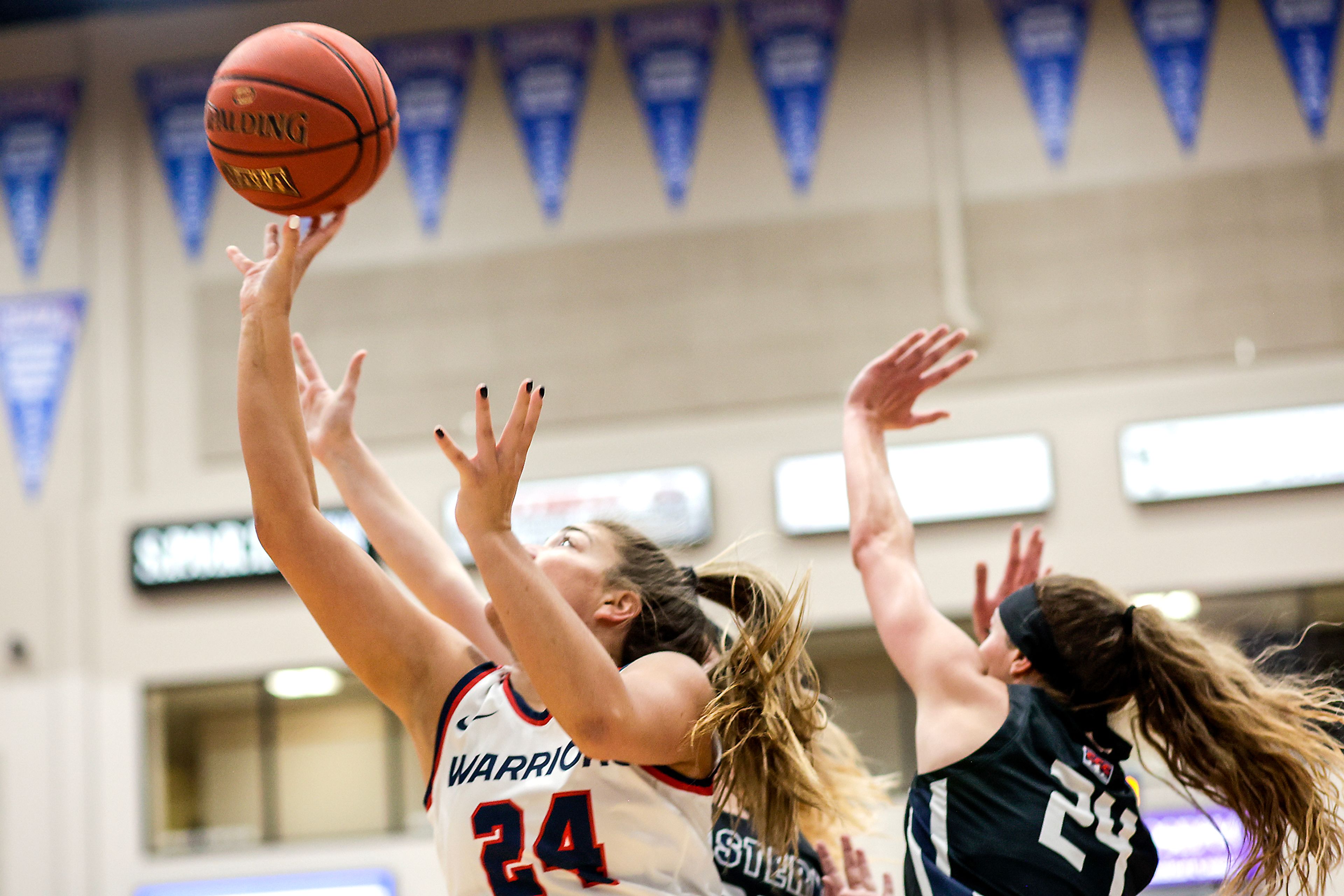 Lewis-Clark State guard Payton Hymas shoots the ball as Eastern Oregon guard Beverly Slater defends during a Cascade Conference game Friday at Lewis-Clark State College.