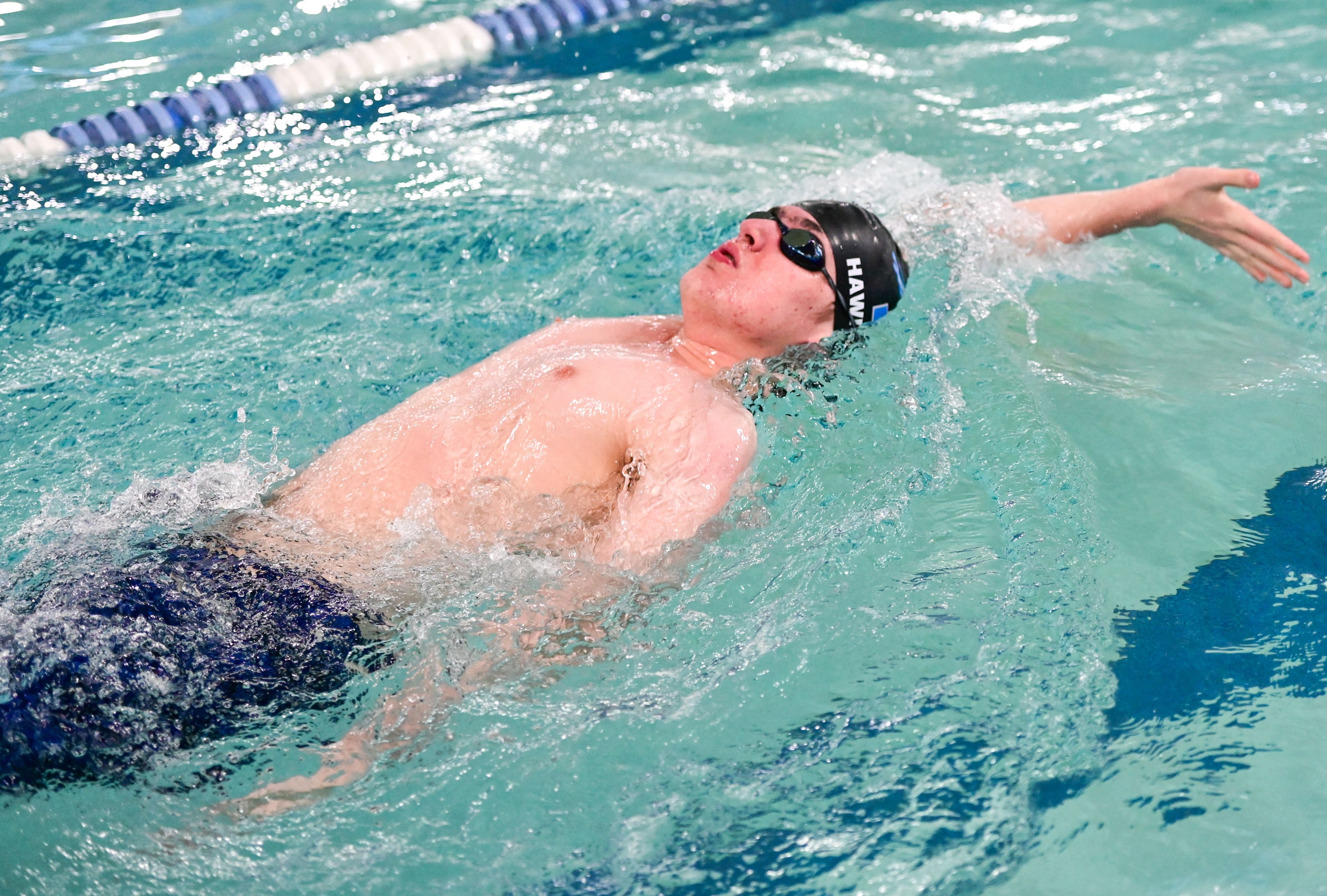 Pullman junior Quincy Hawreliak races in the 100-yard backstroke at a meet with Moses Lake in Pullman on Tuesday.