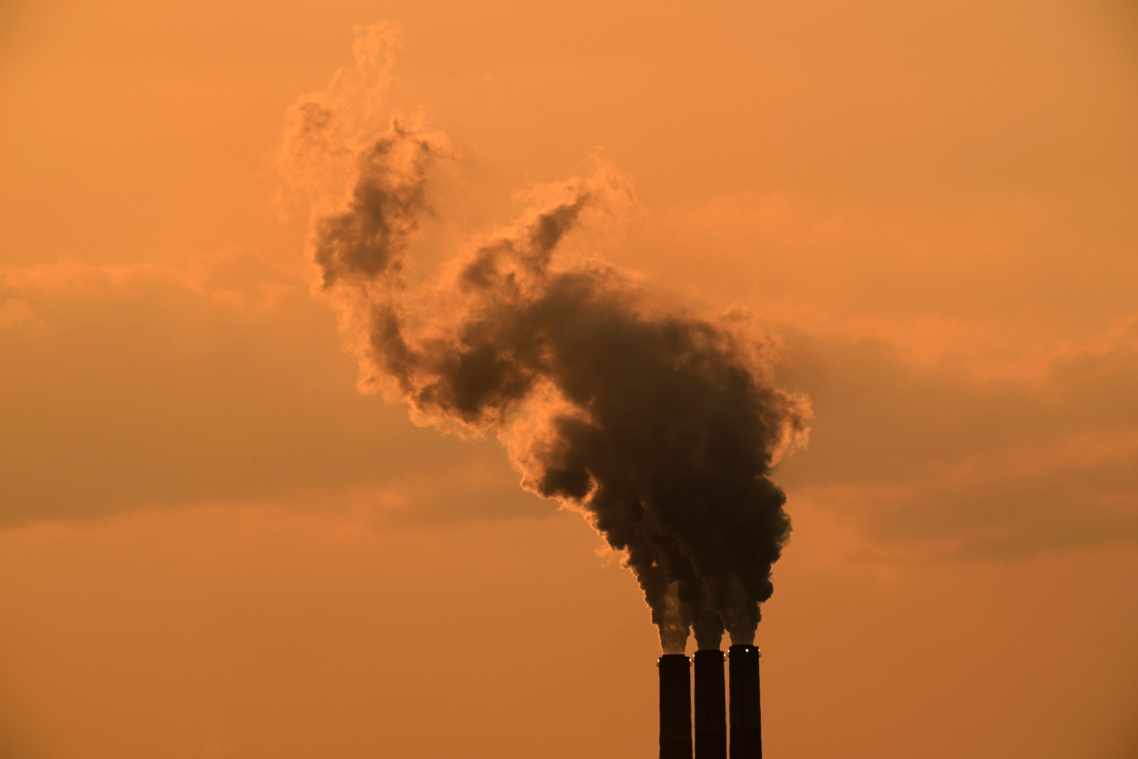 FILE - Smokestacks at the Jeffrey Energy Center coal-fired power plant are silhouetted against the sky at sunset Sept. 12, 2020, near Emmet, Kan. (AP Photo/Charlie Riedel, File)