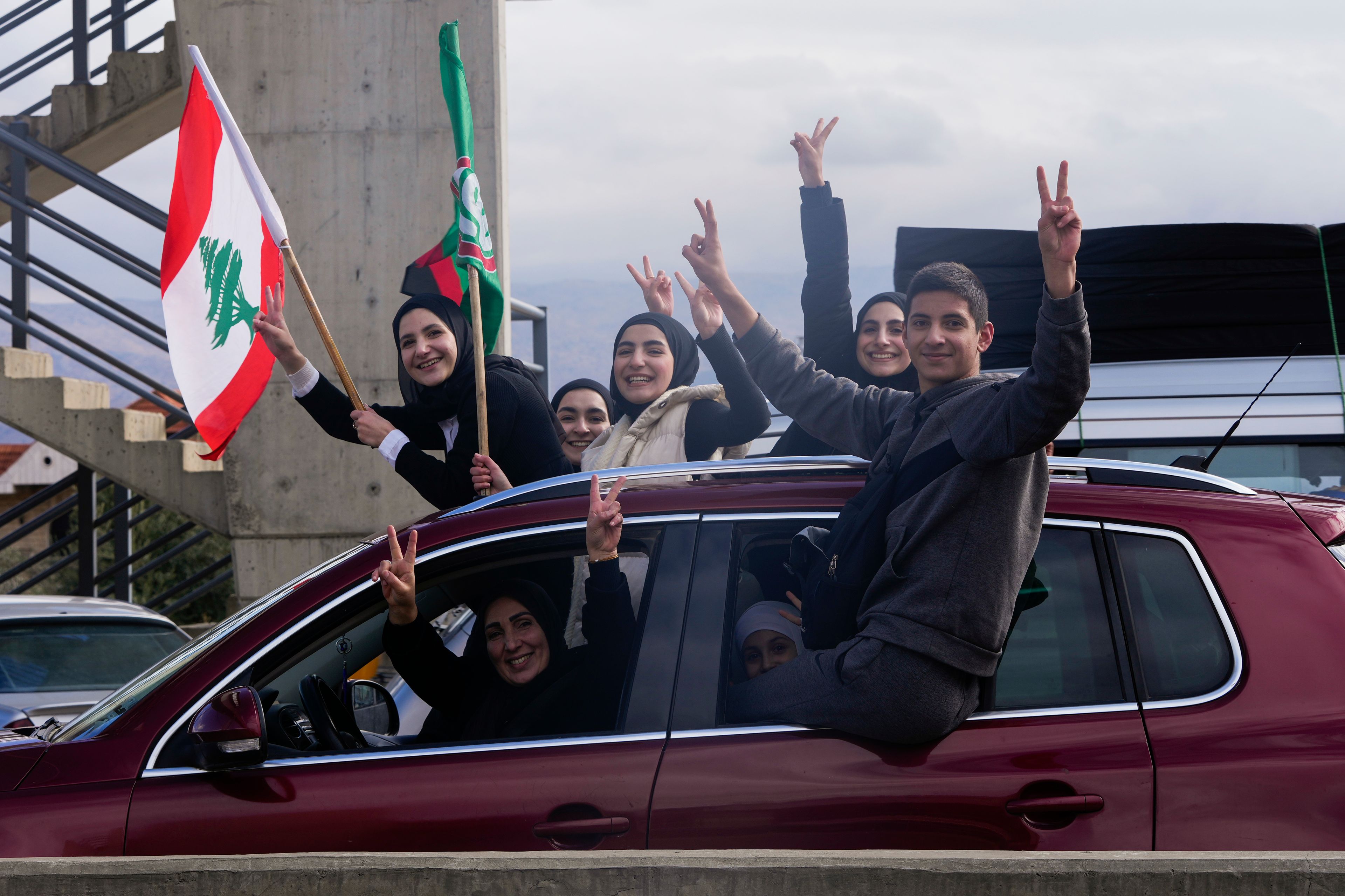 Displaced residents celebrate as they return to their villages following a ceasefire between Israel and Hezbollah that went into effect on Wednesday, Nov. 27, 2024, in Ablah, eastern Lebanon. (AP Photo/Hassan Ammar)