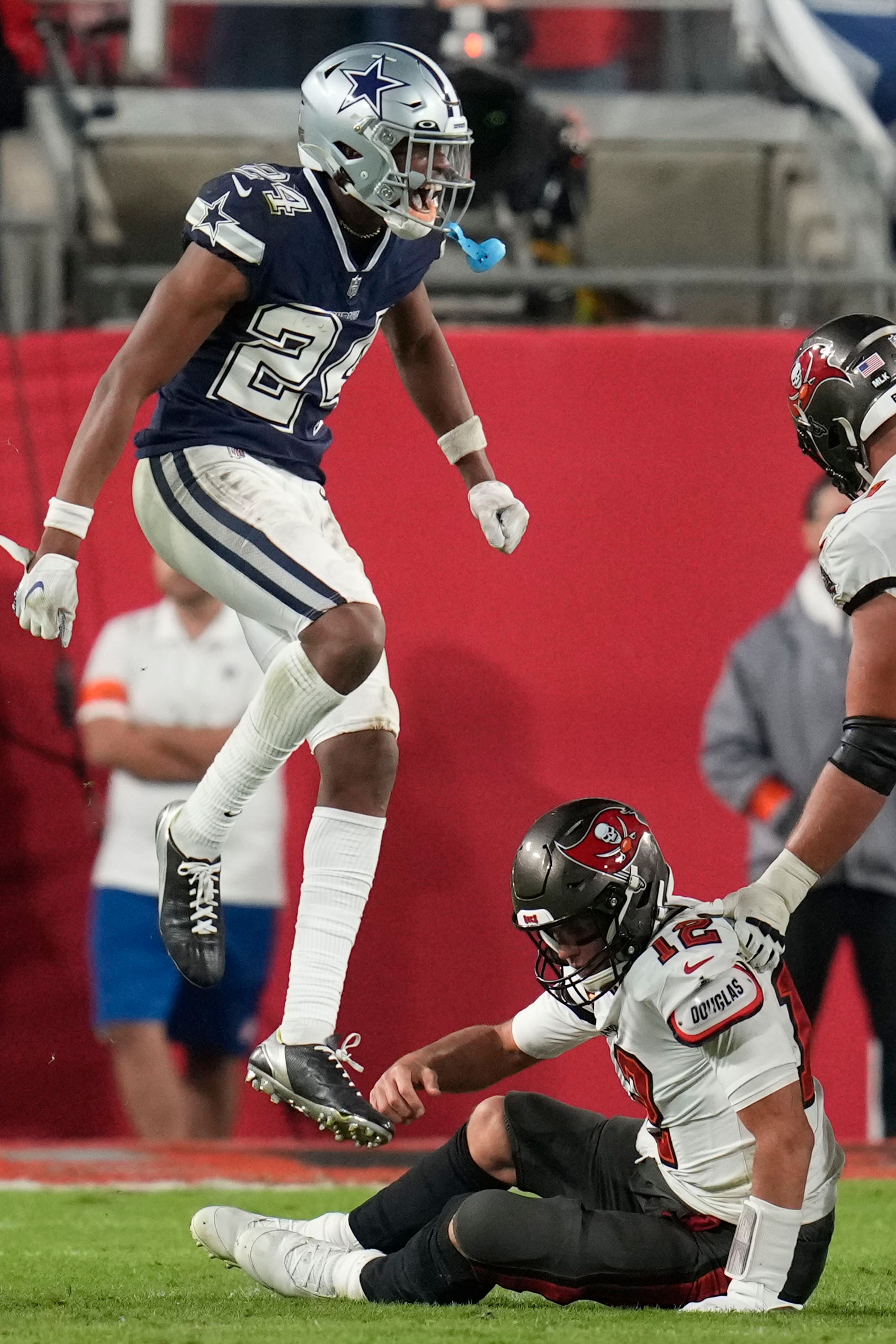 Dallas Cowboys safety Israel Mukuamu (24) celebrates the sacking of Tampa Bay Buccaneers quarterback Tom Brady (12) during the second half of an NFL wild-card football game, Monday, Jan. 16, 2023, in Tampa, Fla. (AP Photo/John Raoux)