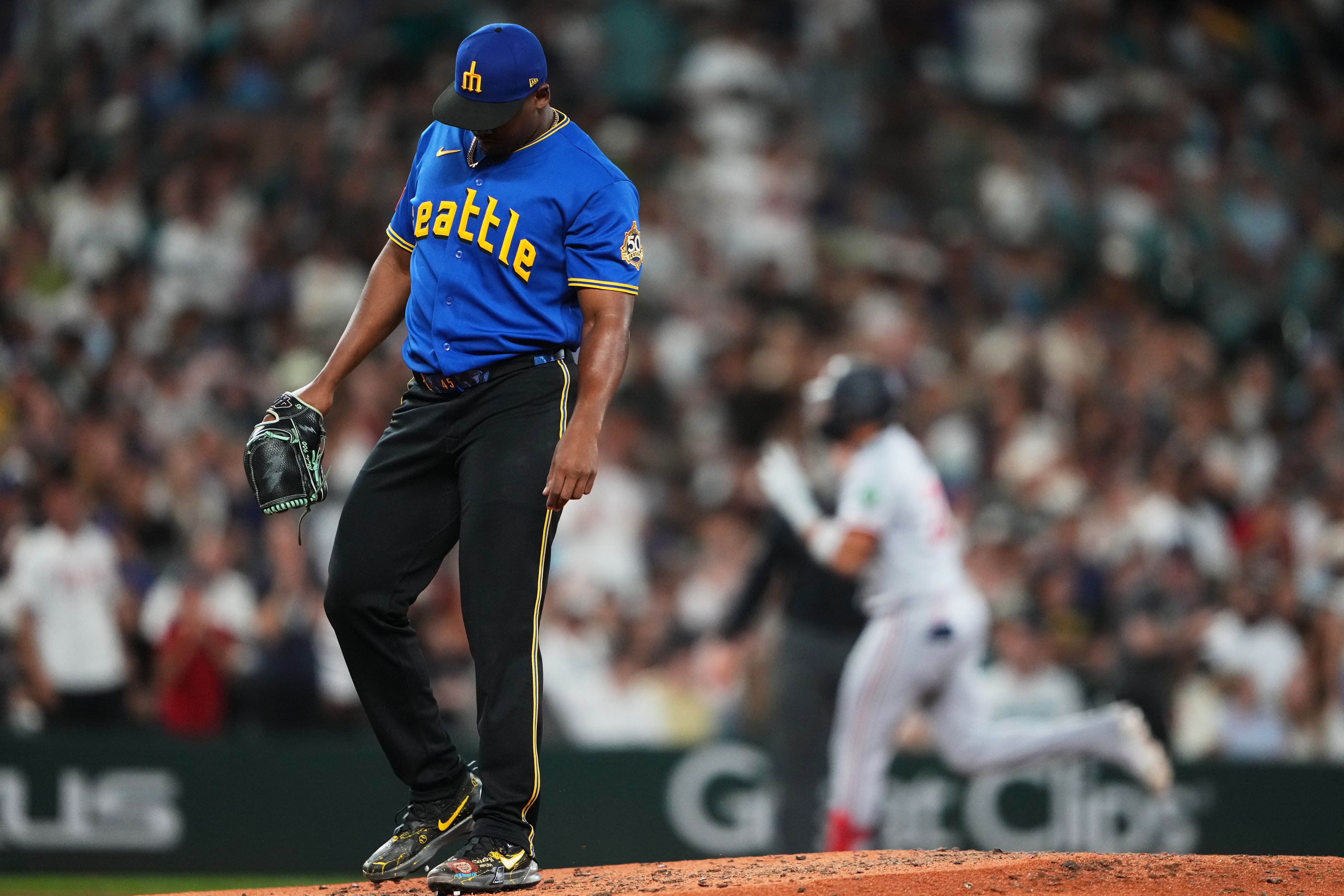 Seattle Mariners relief pitcher Jose A. Ferrer looks down as Minnesota Twins’ Royce Lewis jogs the bases after hitting a solo home run during the seventh inning of a baseball game, Friday, in Seattle. 