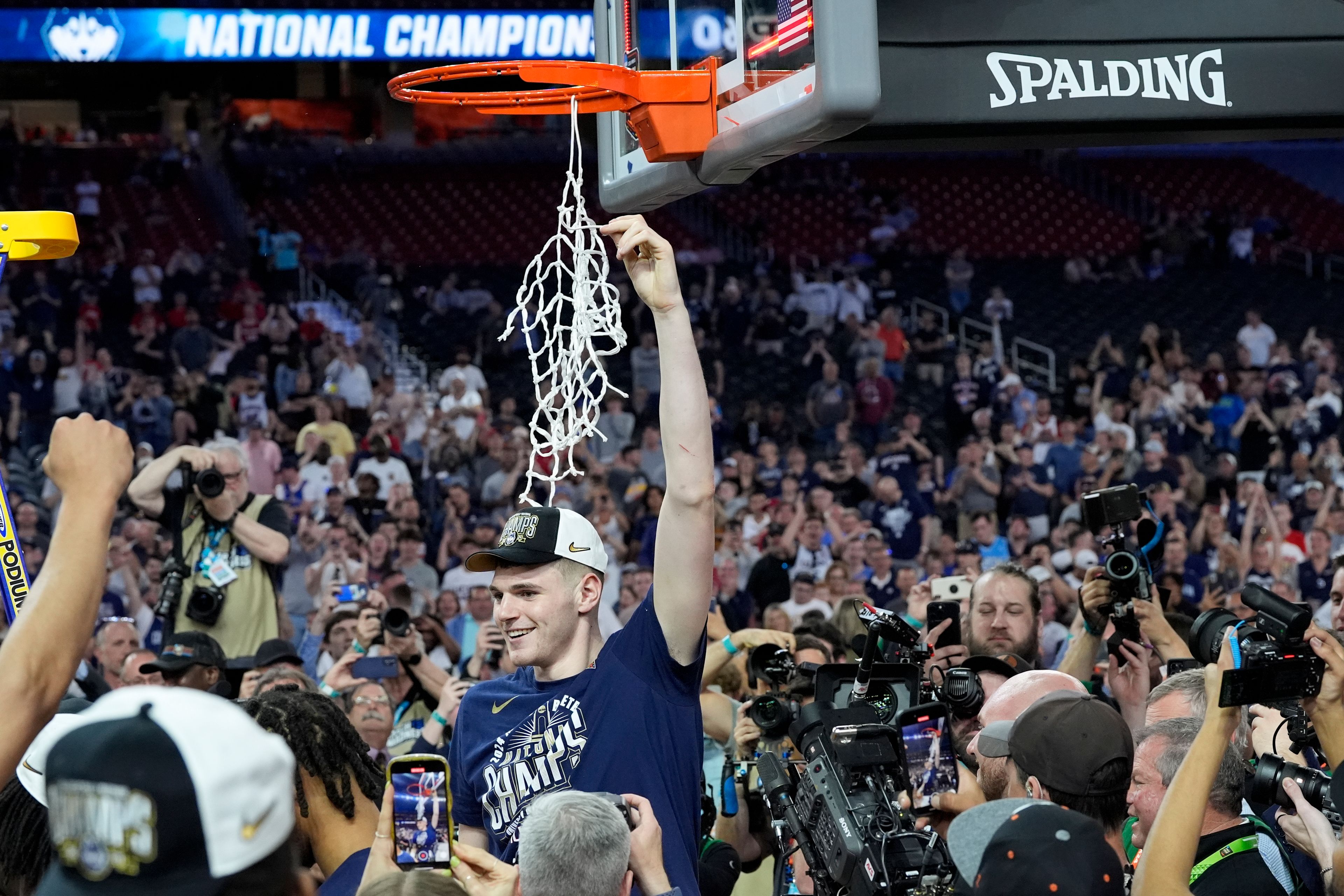 FILE - UConn center Donovan Clingan (32) celebrates cutting the net after their win against Purdue in the NCAA college Final Four championship basketball game, April 8, 2024, in Glendale, Ariz.