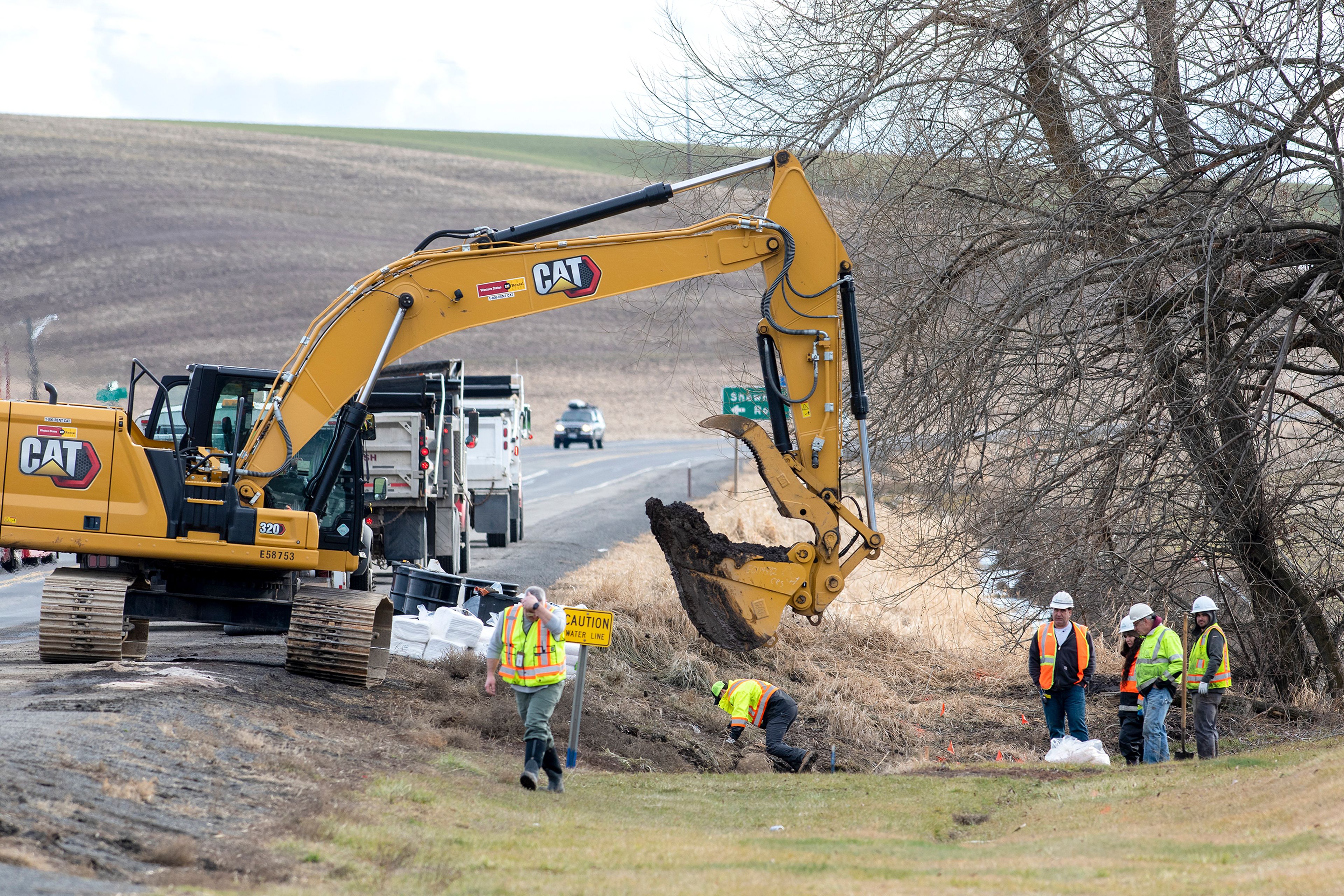 Hazardous materials crews clean an area where a semi-truck hauling fuel crashed and spilled around 6,000 gallons of diesel and gasoline across Highway 195 south of Colfax on Monday.