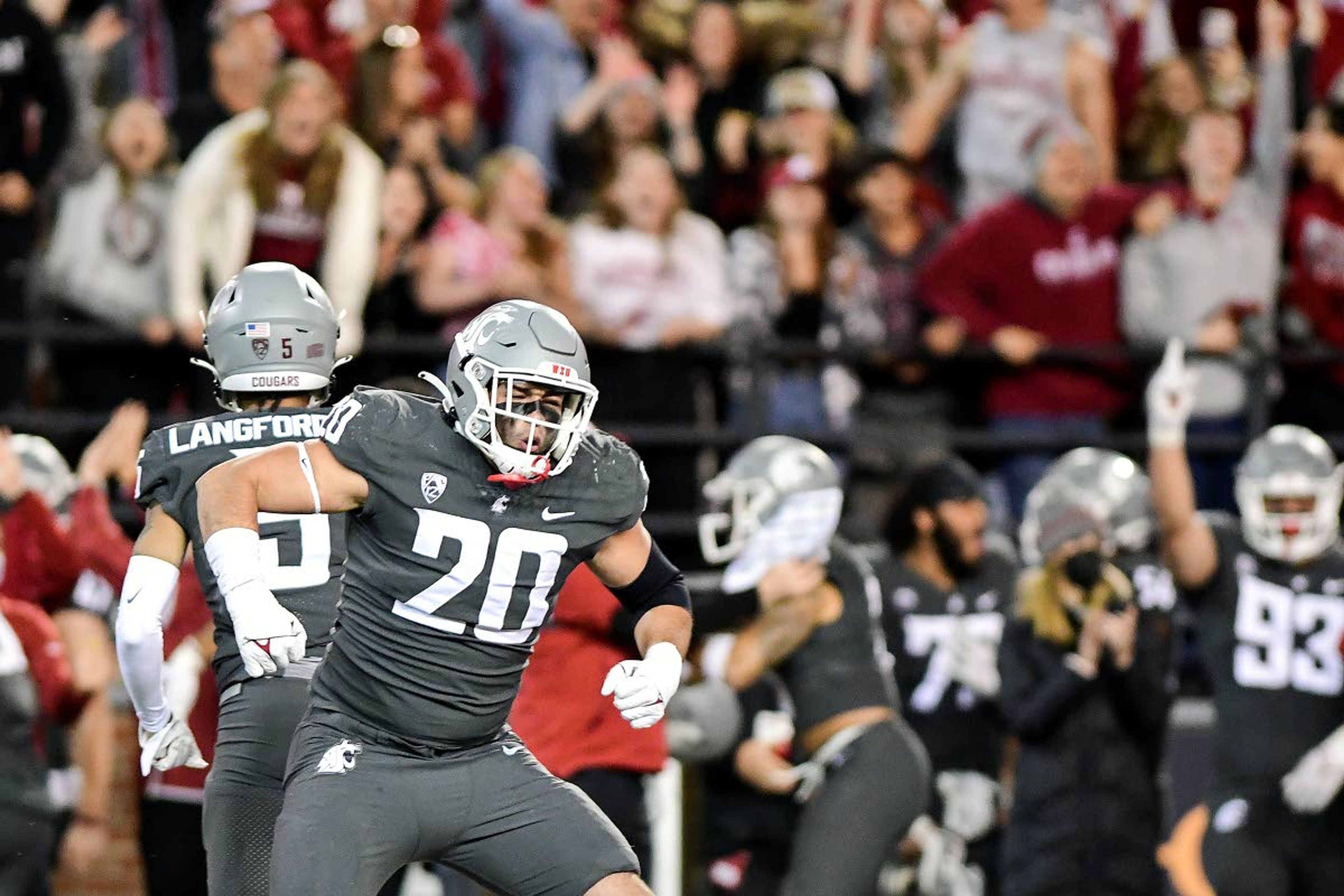 Washington State defensive end Quinn Roff, front, and defensive back Derrick Langford celebrate after Roff forced a fumble when he sacked Stanford quarterback Tanner McKee late in the fourth quarter of an Oct. 16 Pac-12 game at Gesa Field in Pullman. The Cougars were slight underdogs for most of that week against the Cardinal.