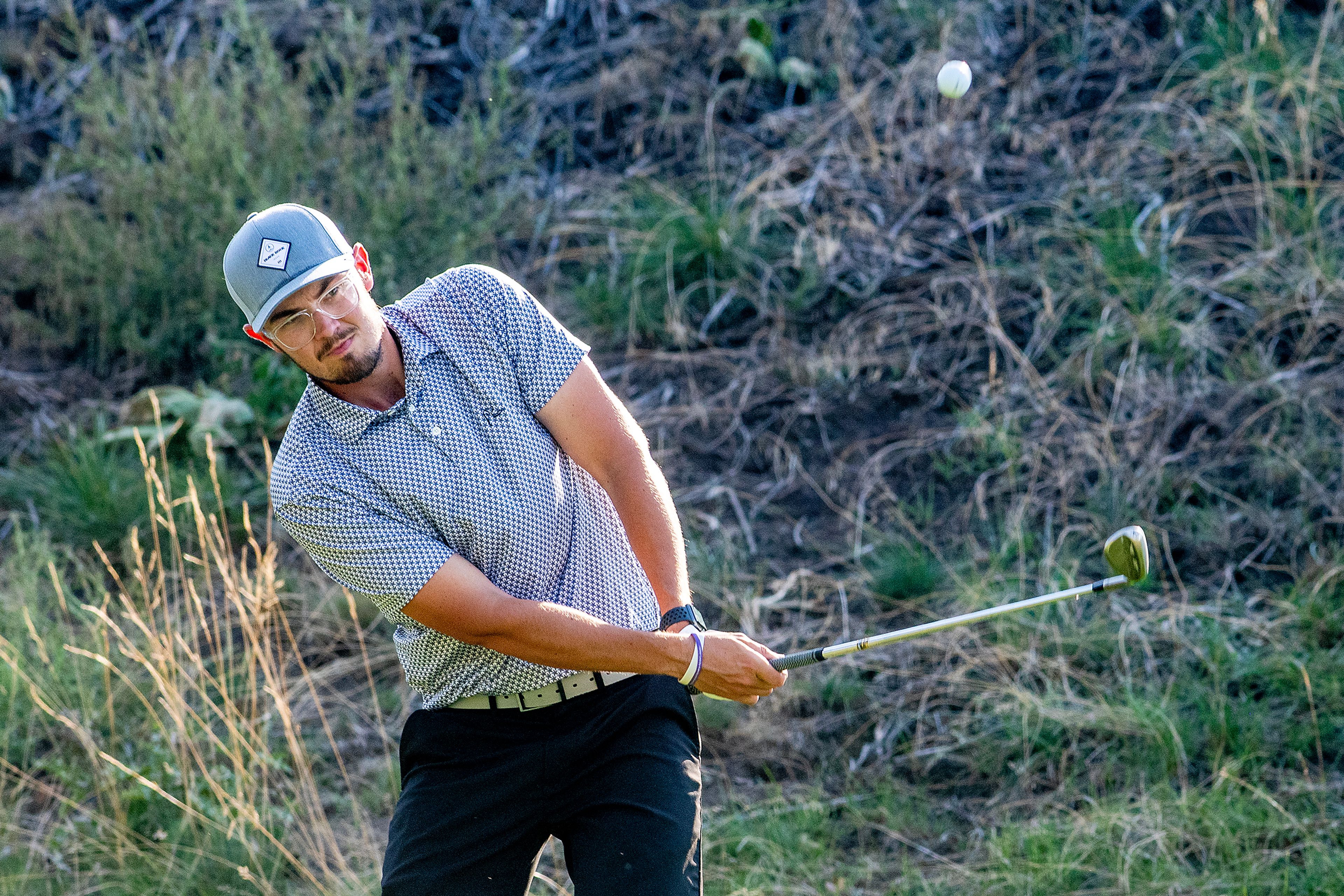 Zach Anderson hits his ball in a chip off at the Sole Survivor Tournament Monday at the Lewiston Golf and Country Club.