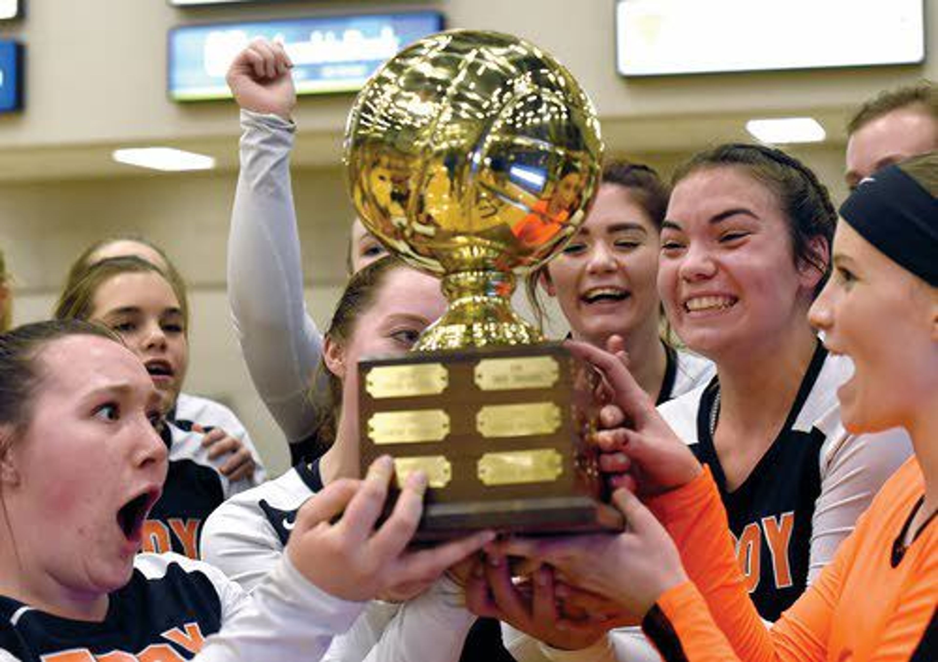 Troy players gladly accept the Class 1A Division I District II volleyball trophy after beating Genesee 3-1 on Tuesday night at the Lewis-Clark State College Activity Center. With the victory, the Trojans wrapped up a trip to the state tournament, of which they are the defending champions.