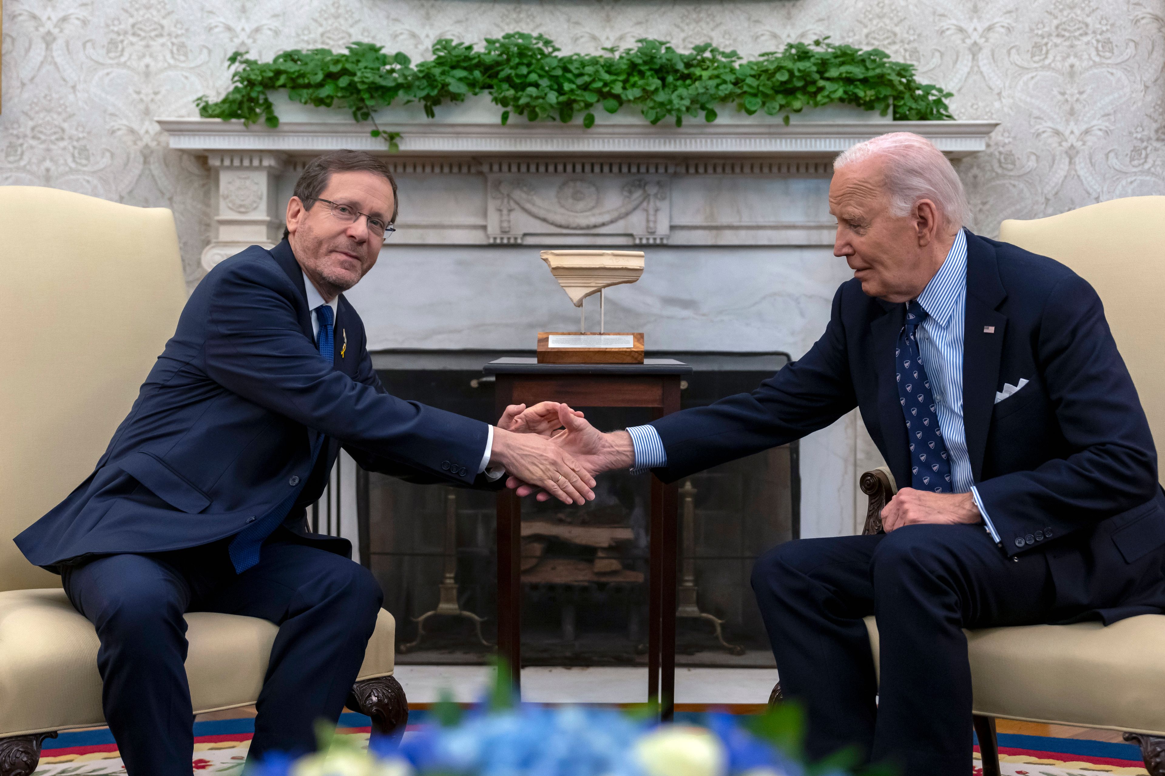 President Joe Biden shakes hands with Israel's President Isaac Herzog, left, during a meeting in the Oval Office of the White House in Washington, Tuesday, Nov. 12, 2024. (AP Photo/Ben Curtis)