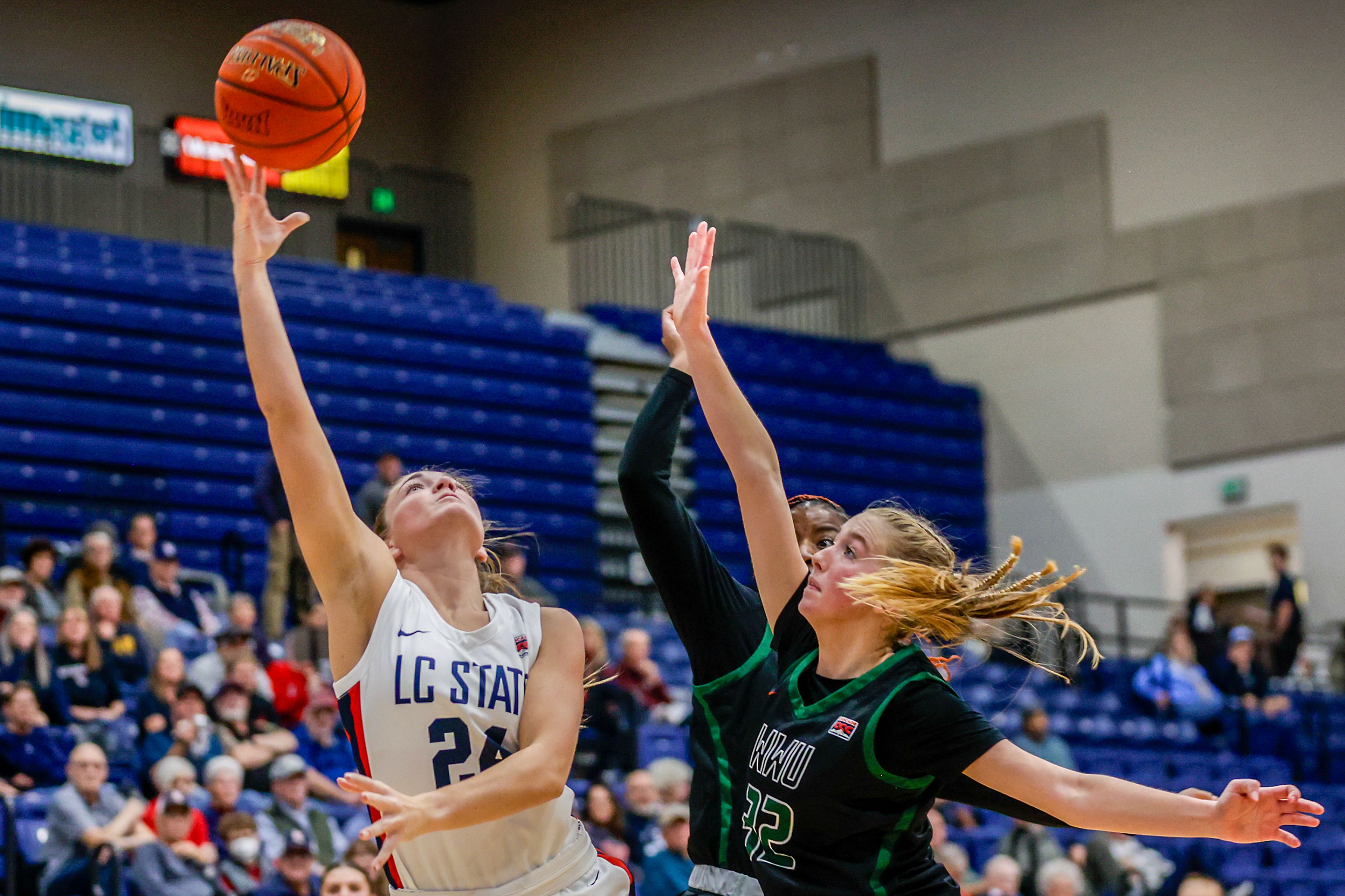 Lewis-Clark State guard Payton Hymas shoots the ball under pressure from Walla Walla center Sidney Folkenberg during a quarter of a Cascade Conference game Tuesday at Lewis-Clark State College in Lewiston.