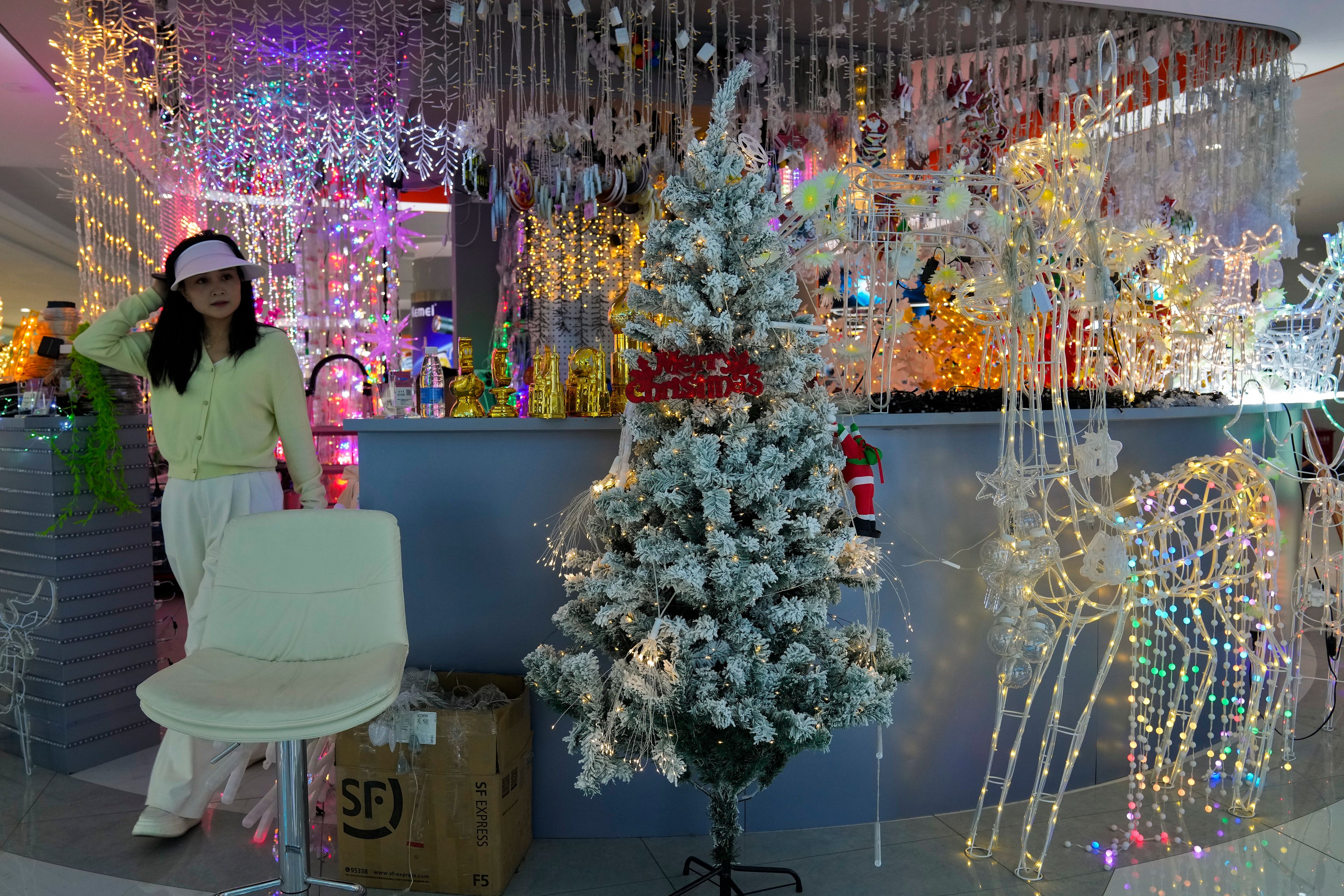 A woman walks out from a store selling decorative lights at the Yiwu wholesale market in Yiwu, east China's Zhejiang province on Nov. 8, 2024. (AP Photo/Andy Wong)