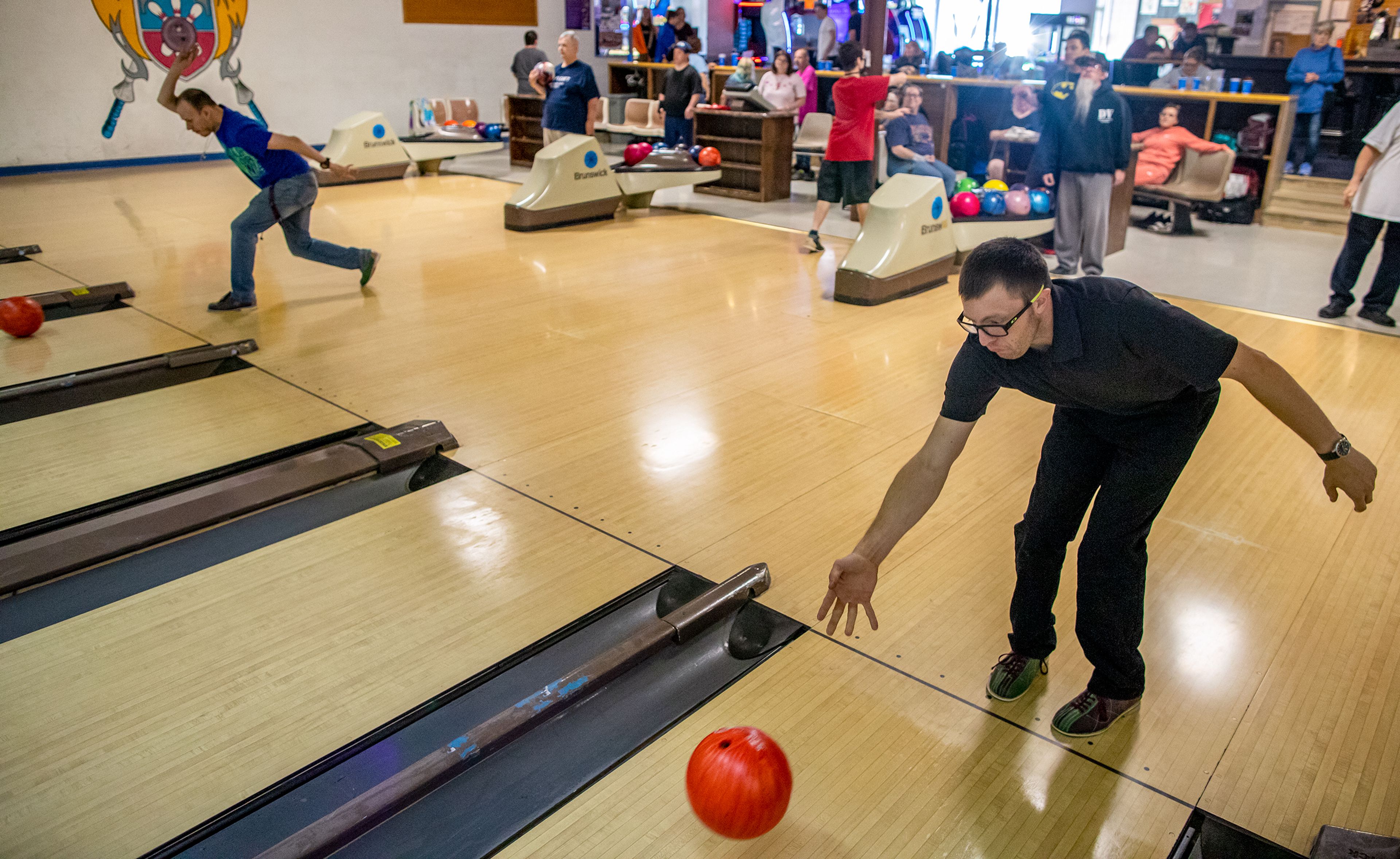 Clayton Evans, right, of the Twin Rivers Special Olympics of Washington, rolls a frame during a team practice Saturday morning at Lancer Lanes in Clarkston.