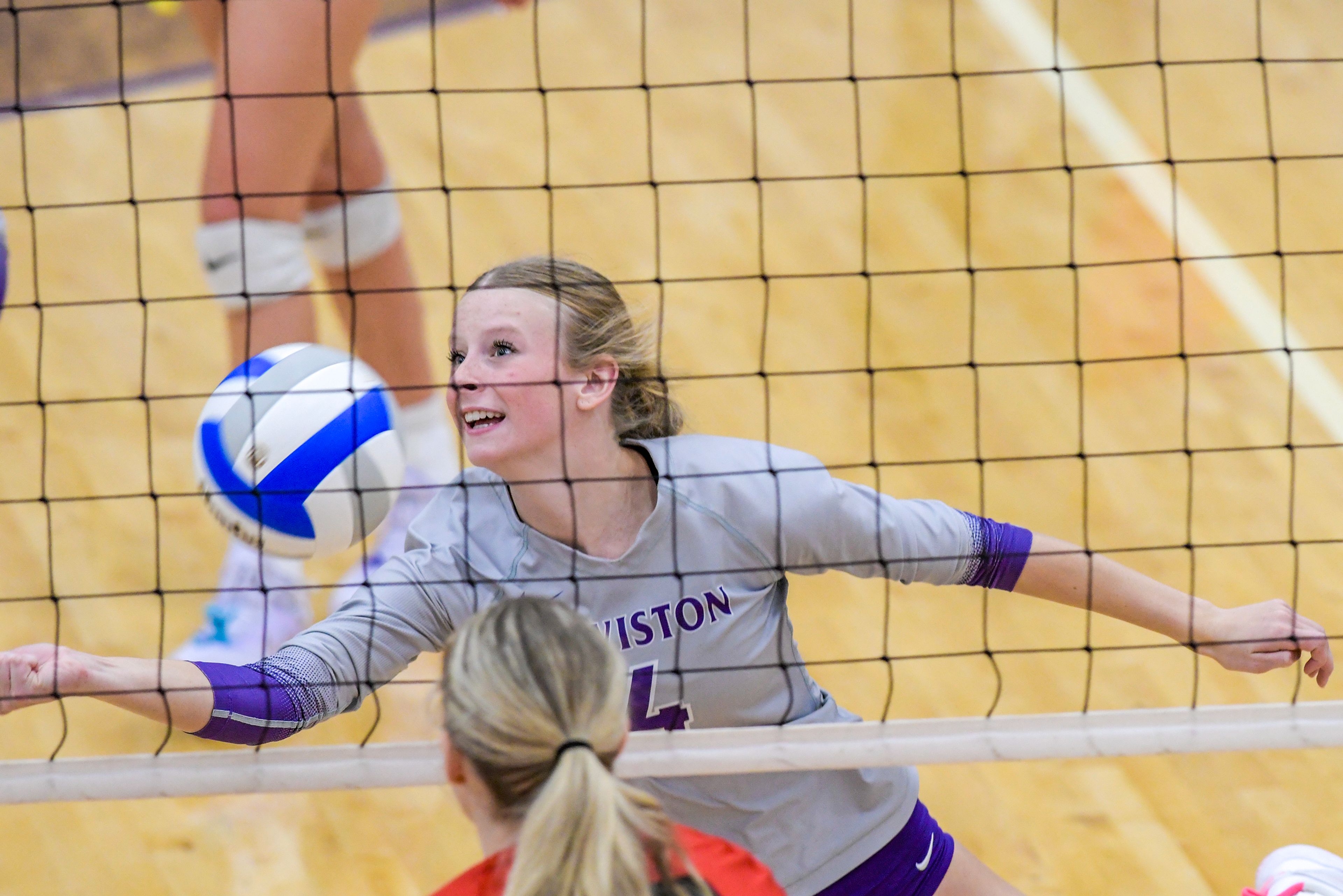 Lewiston middle blocker Jordan Albright tries to keep the ball in play against Sandpoint during a volleyball game Thursday in Lewiston.,