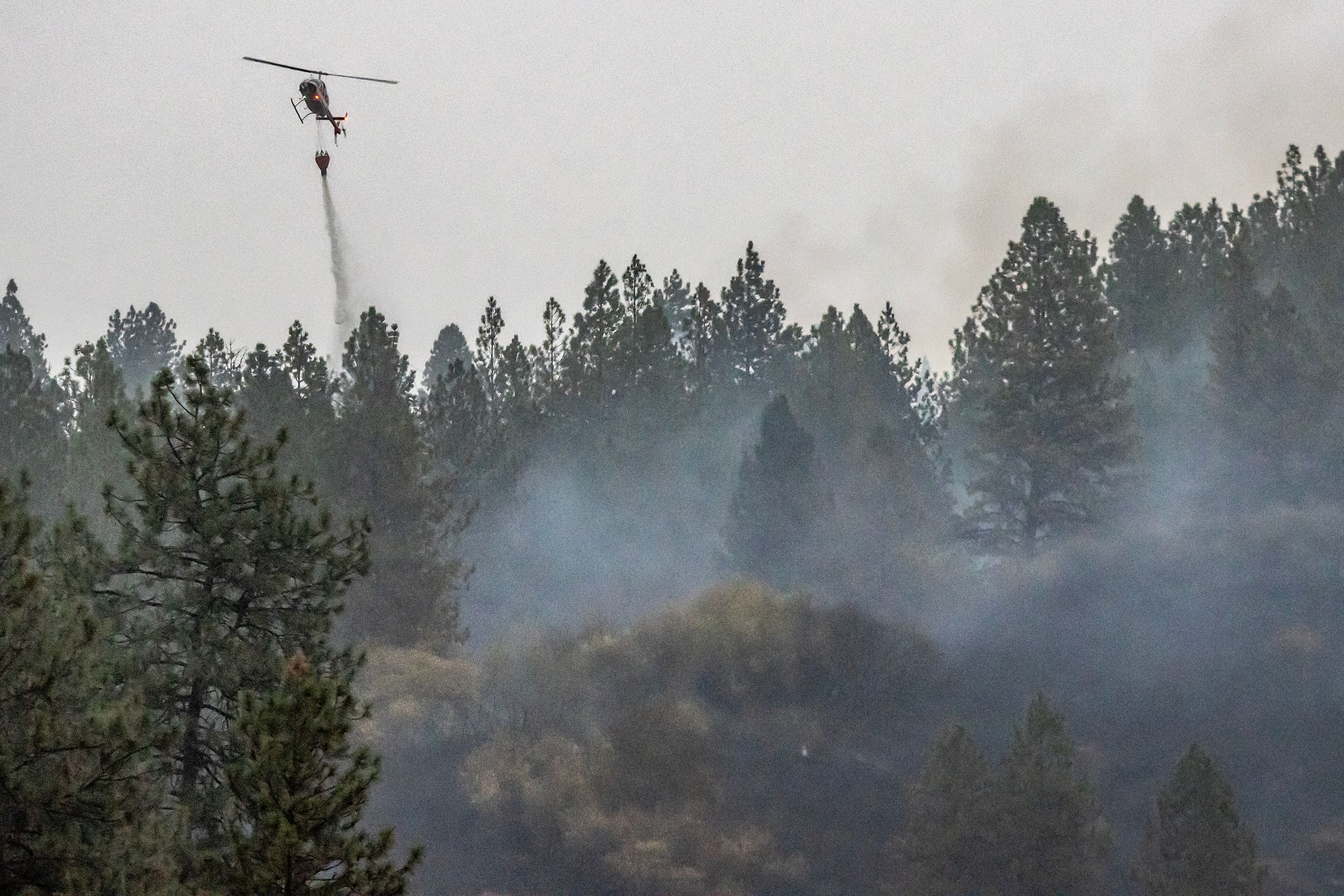 A helicopter makes drops on a fire off of Dent Bridge Road Tuesday near Orofino.