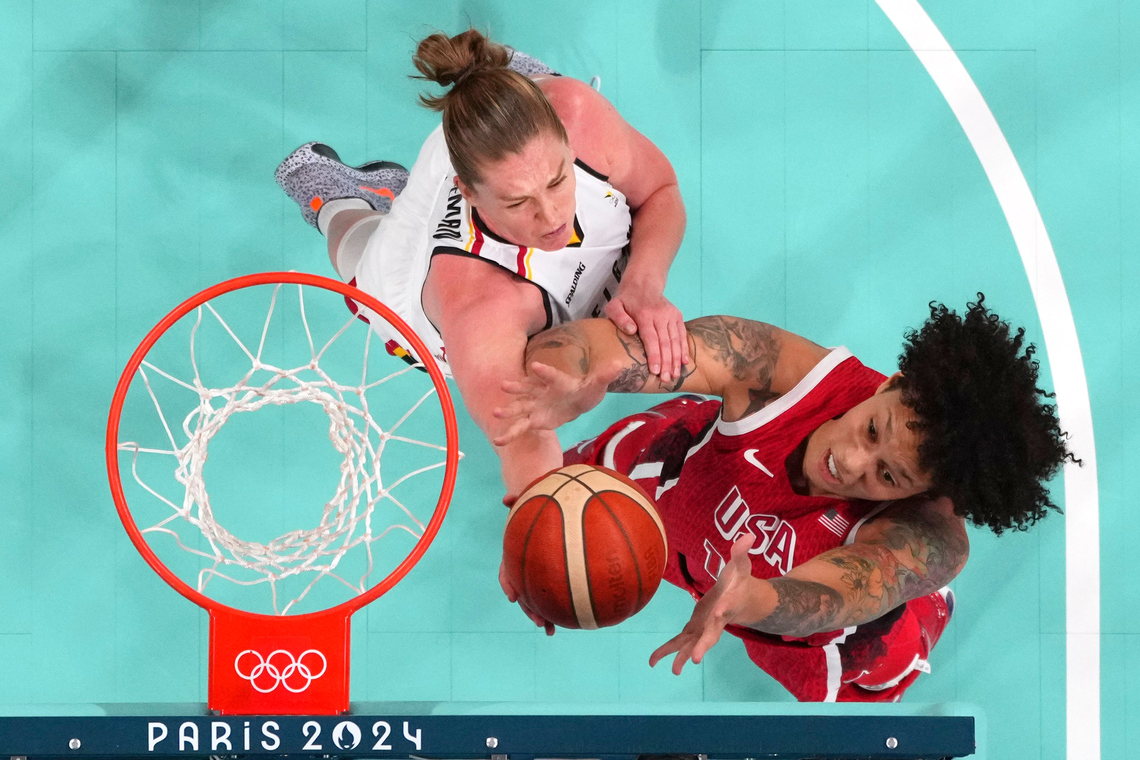 United States' Brittney Griner, right, and Belgium's Emma Meesseman reach for a rebound in a women's basketball game at the 2024 Summer Olympics, Thursday, Aug. 1, 2024, in Villeneuve-d'Ascq, France. (Evelyn Hockstein/Pool Photo via AP)