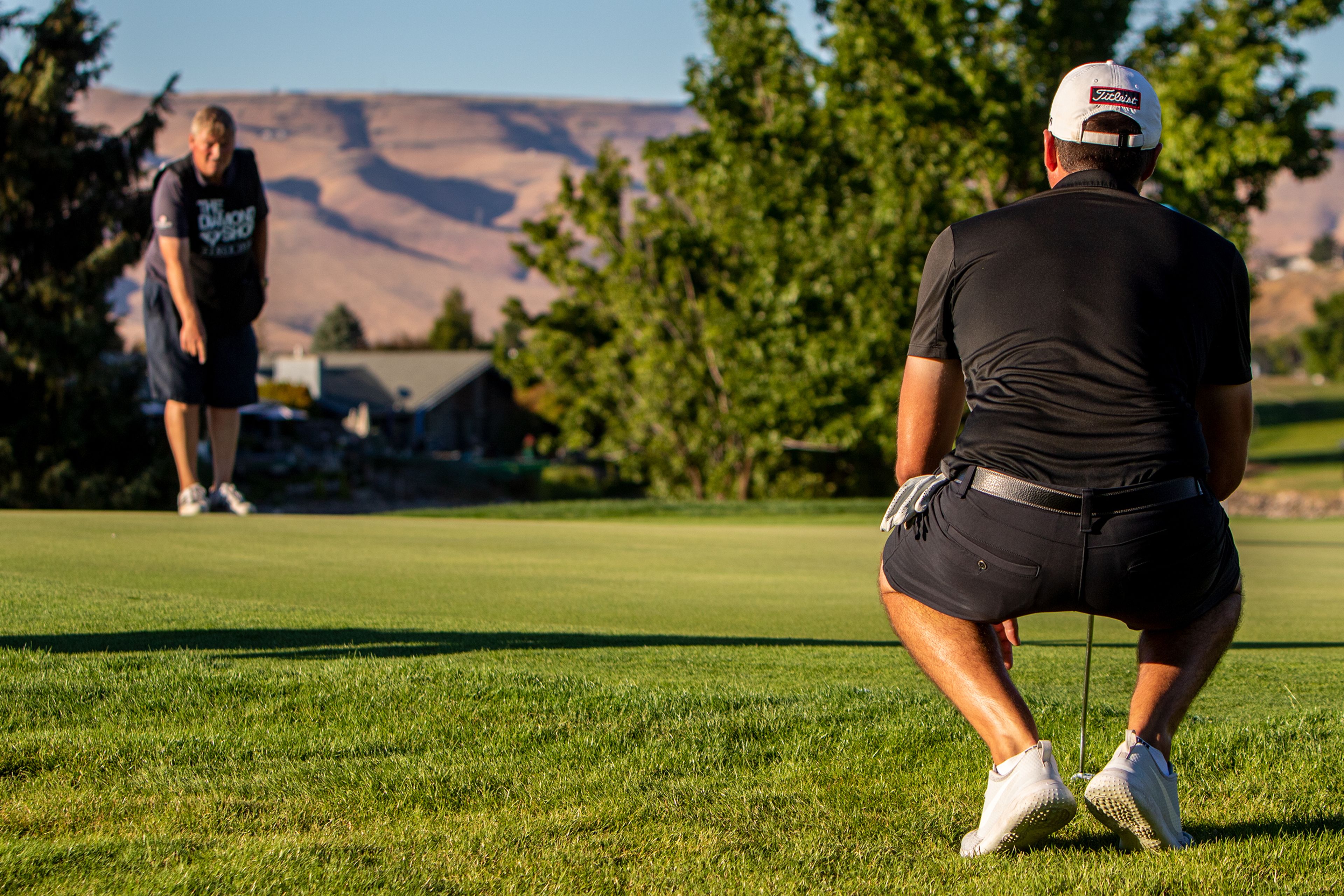 Jared Mraz, of Clarkston, lines up his putt with help from his caddy on the last hole of the 2022 Sole Survivor golf tournament Monday at the Lewiston Golf and Country Club. Mraz took home second place in this year’s competition.