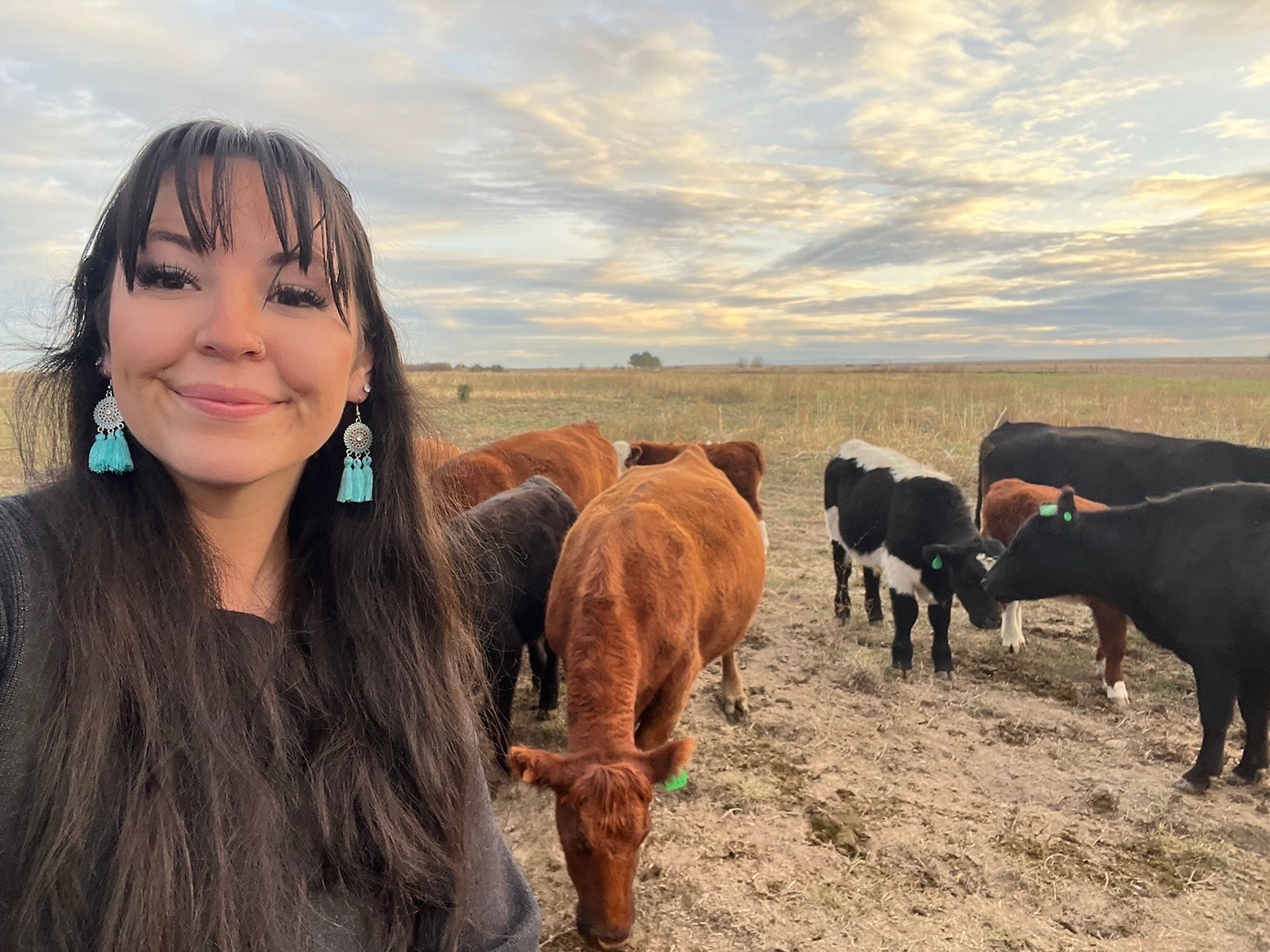 Tessa Guinn is pictured with cows.