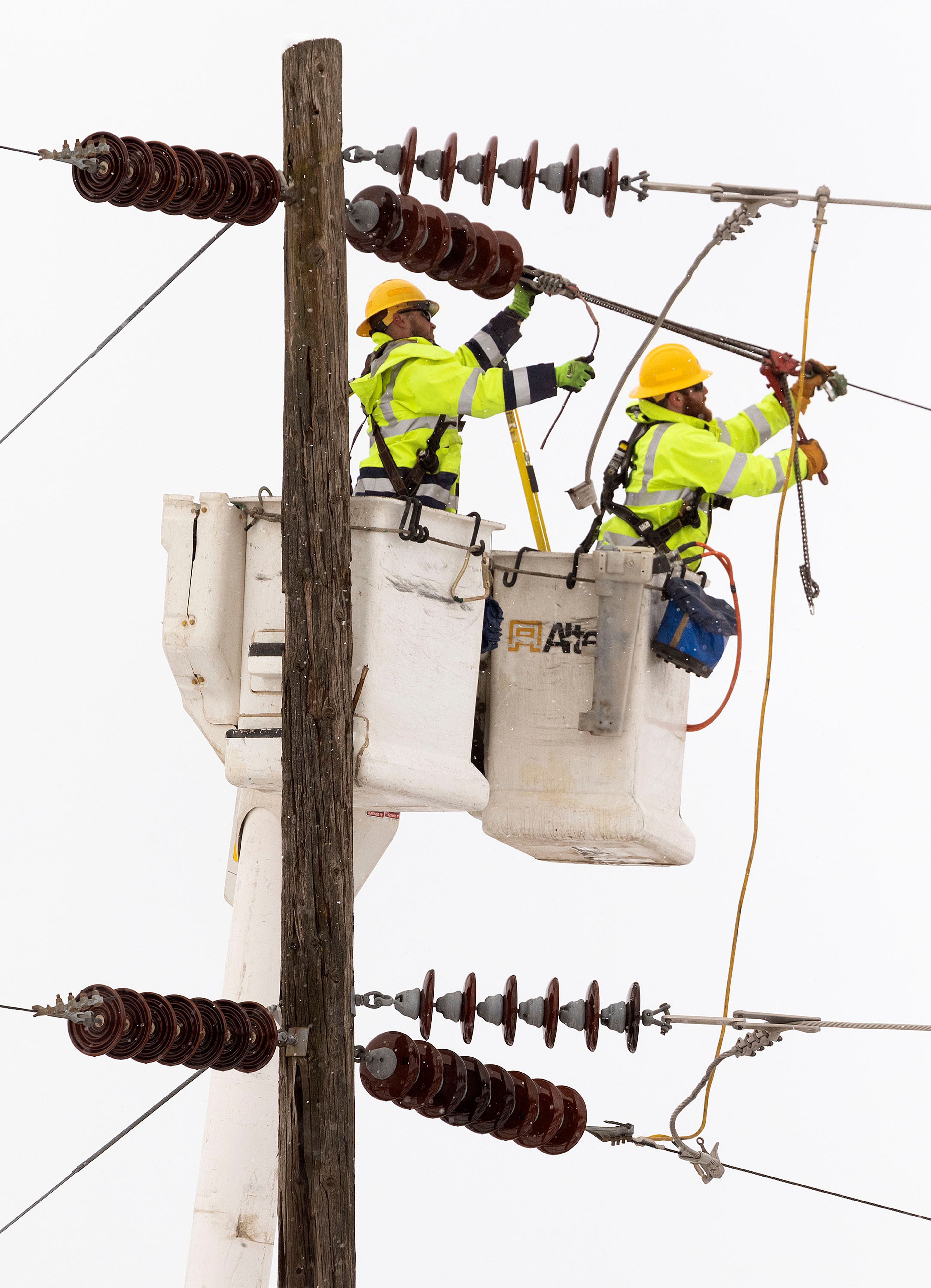 Linemen from Avista Utilities work on a power line near the intersection of Mountain View Road and White Avenue on Wednesday in Moscow.