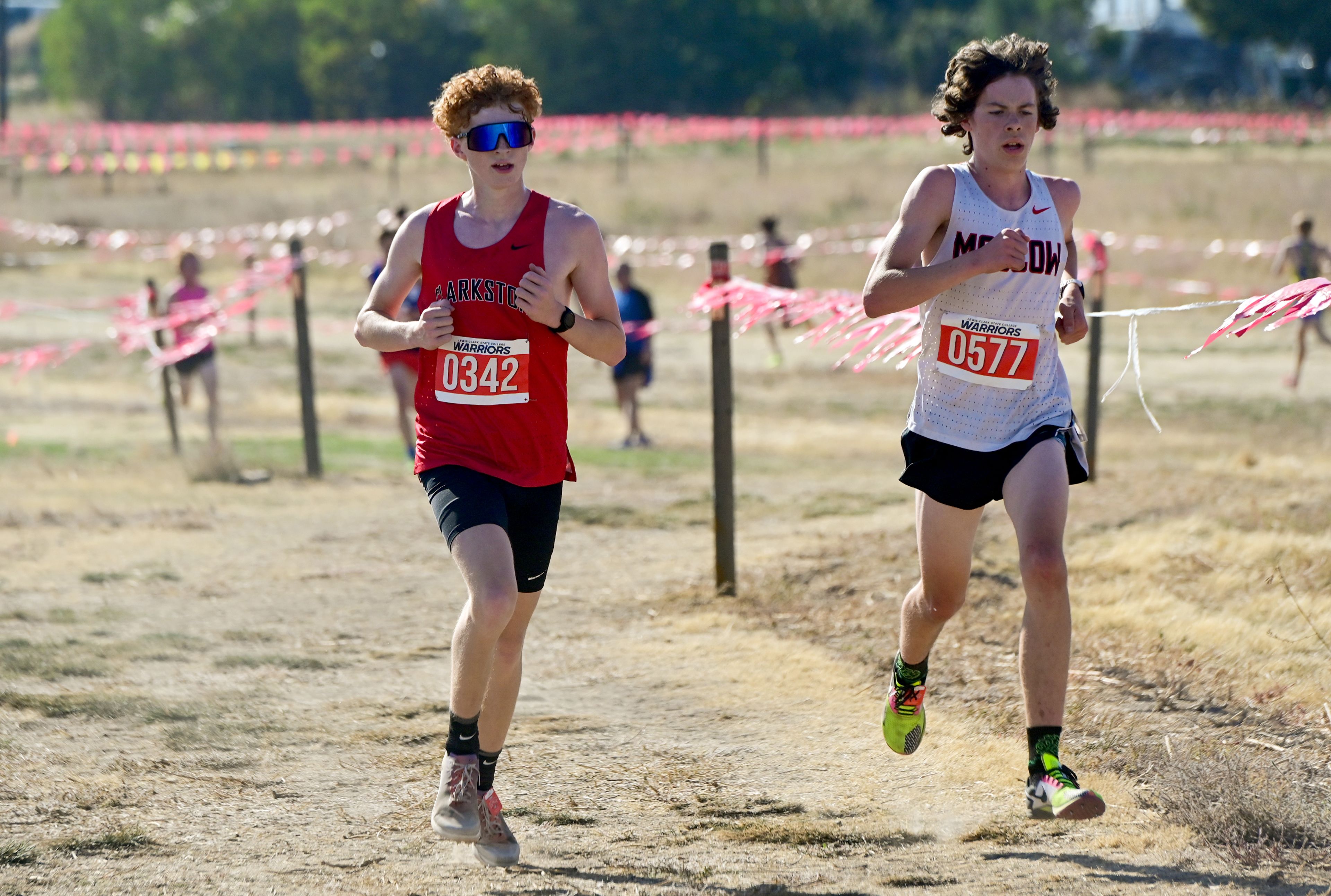 Clarkston's Avery Peters, left, and Moscow's Orion McClory, right, compete in the Inland Empire Championships varsity boys 5K Saturday along the LCSC XC Course in Lewiston.,