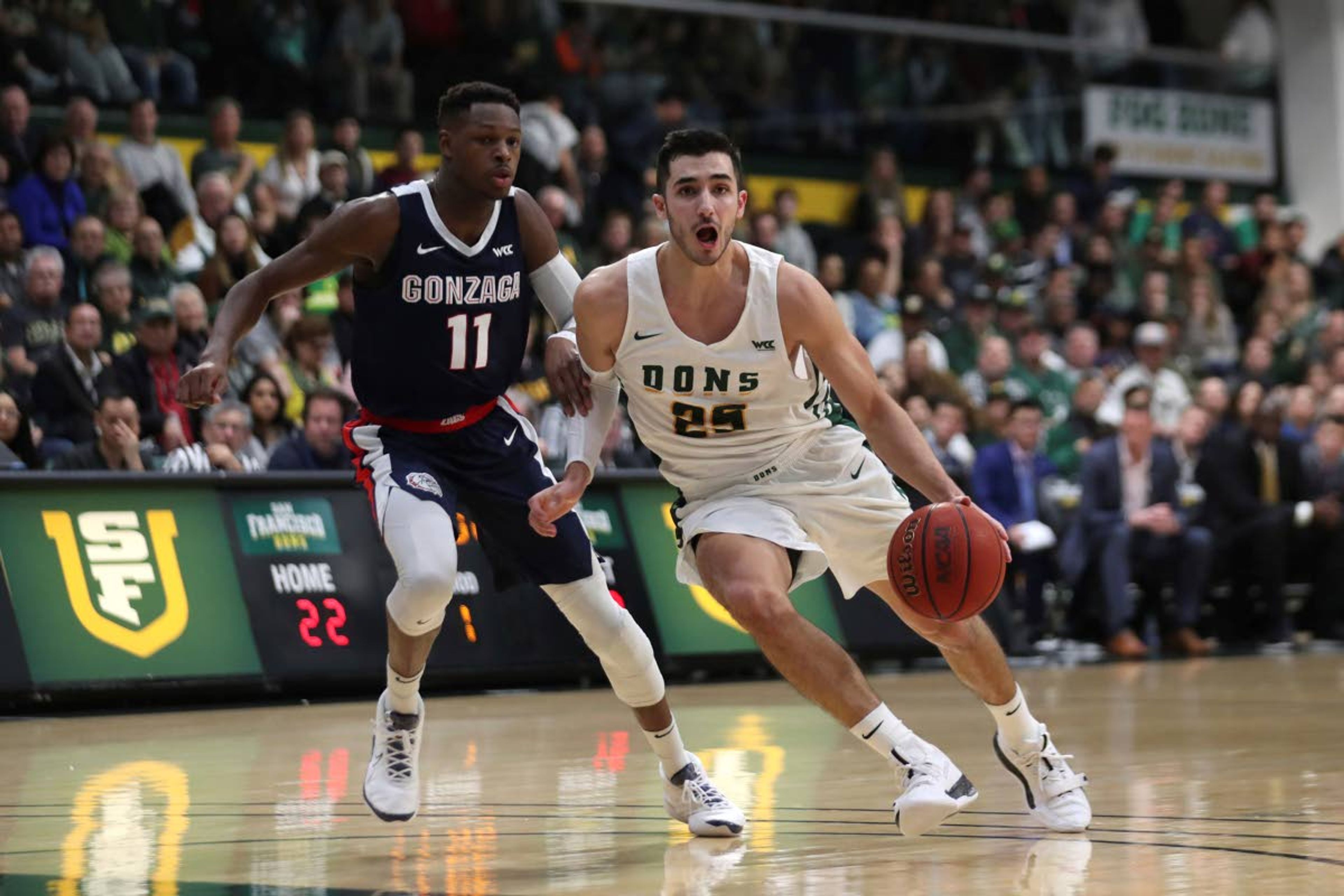 San Francisco guard Jordan Ratinho (25) drives against Gonzaga guard Joel Ayayi (11) during the first half of an NCAA college basketball game in San Francisco, Saturday, Feb. 1, 2020. (AP Photo/Jed Jacobsohn)