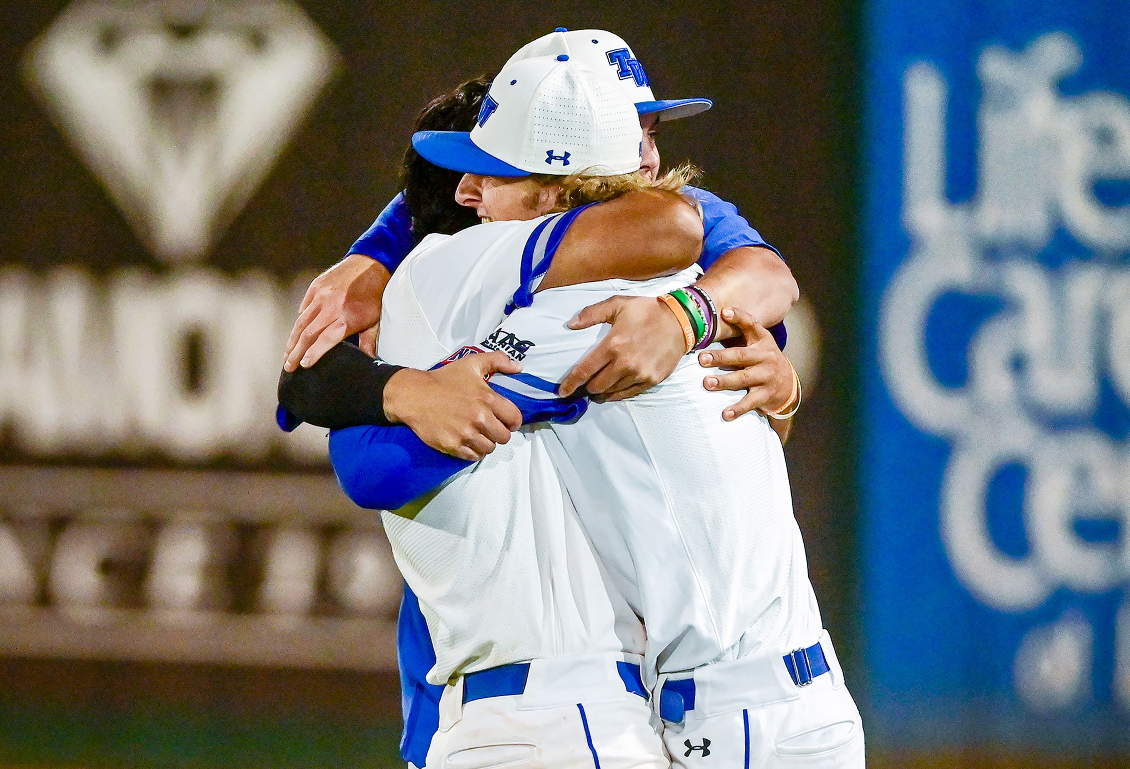 Tennessee Wesleyan players embrace after their win over Reinhardt in Game 18 of the NAIA World Series on Thursday at Harris Field in Lewiston.