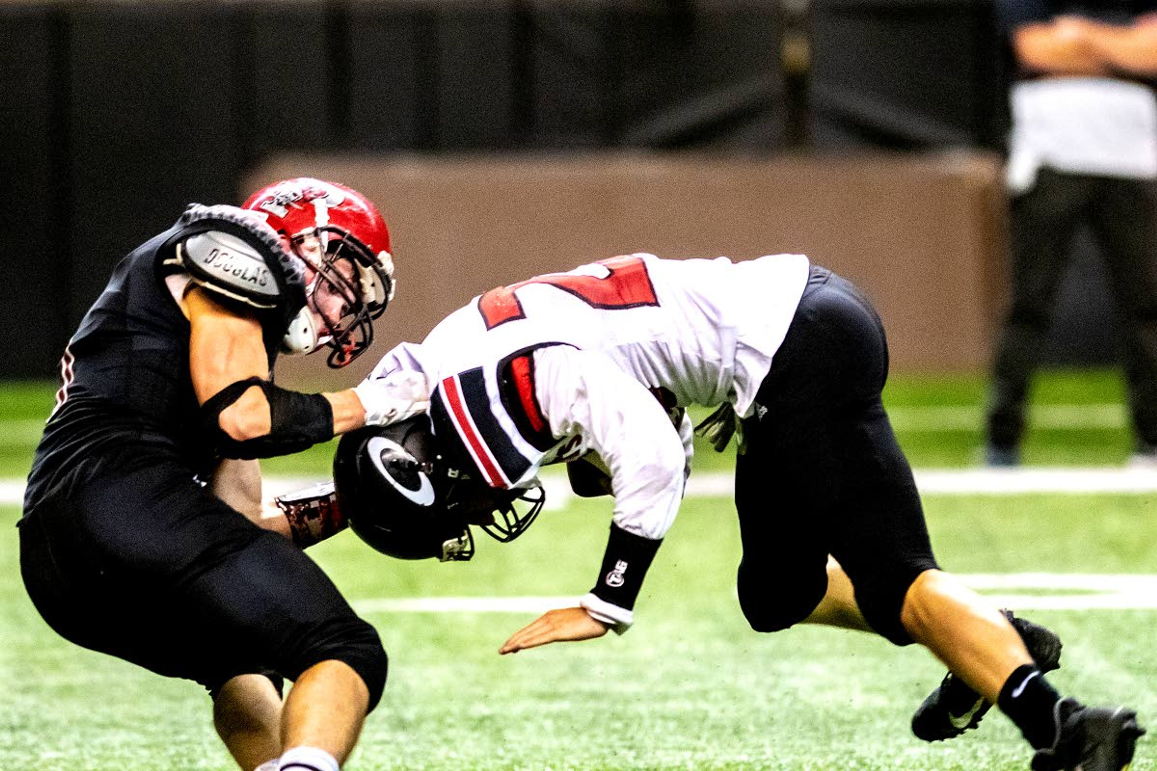 Prairie’s Tayden Hibbard pulls Oakley’s Everett Jackson to the ground during a Class 1A Division I state semifinal game Friday at the University of Idaho’s Kibbie Dome.