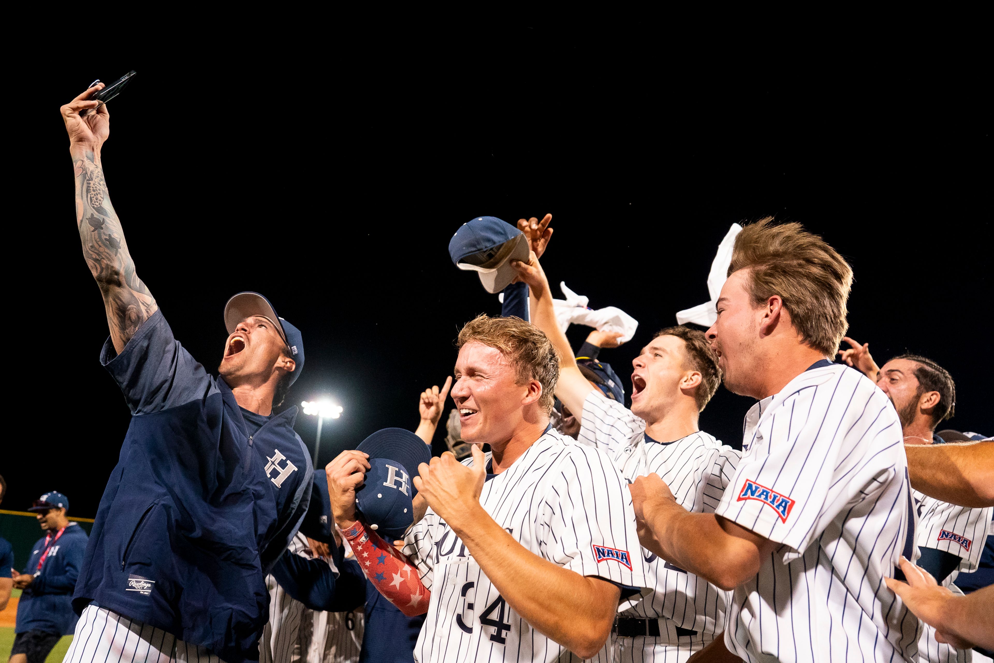 Hope International players celebrate after winning Game 19 of the NAIA World Series against Tennessee Wesleyan on Friday at Harris Field in Lewiston.