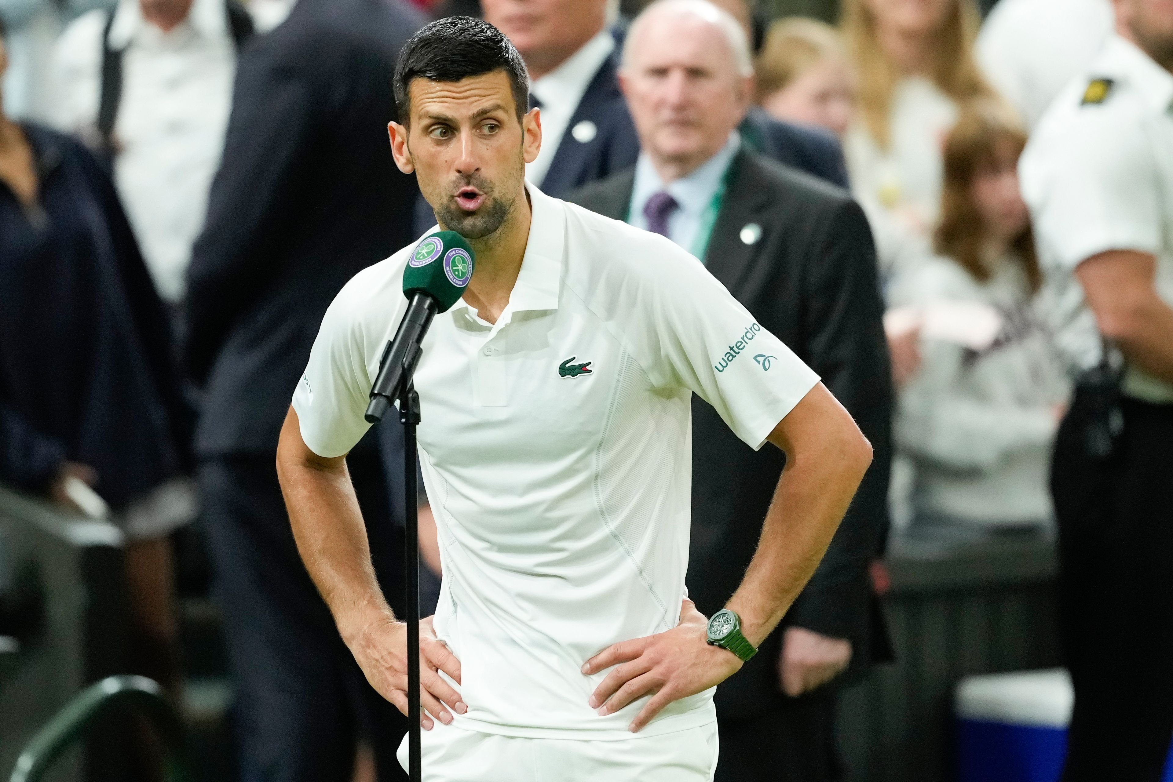 Novak Djokovic of Serbia reacts as he is interviewed after defeating Holger Rune of Denmark in their fourth round match at the Wimbledon tennis championships in London, Monday, July 8, 2024. (AP Photo/Mosa'ab Elshamy)