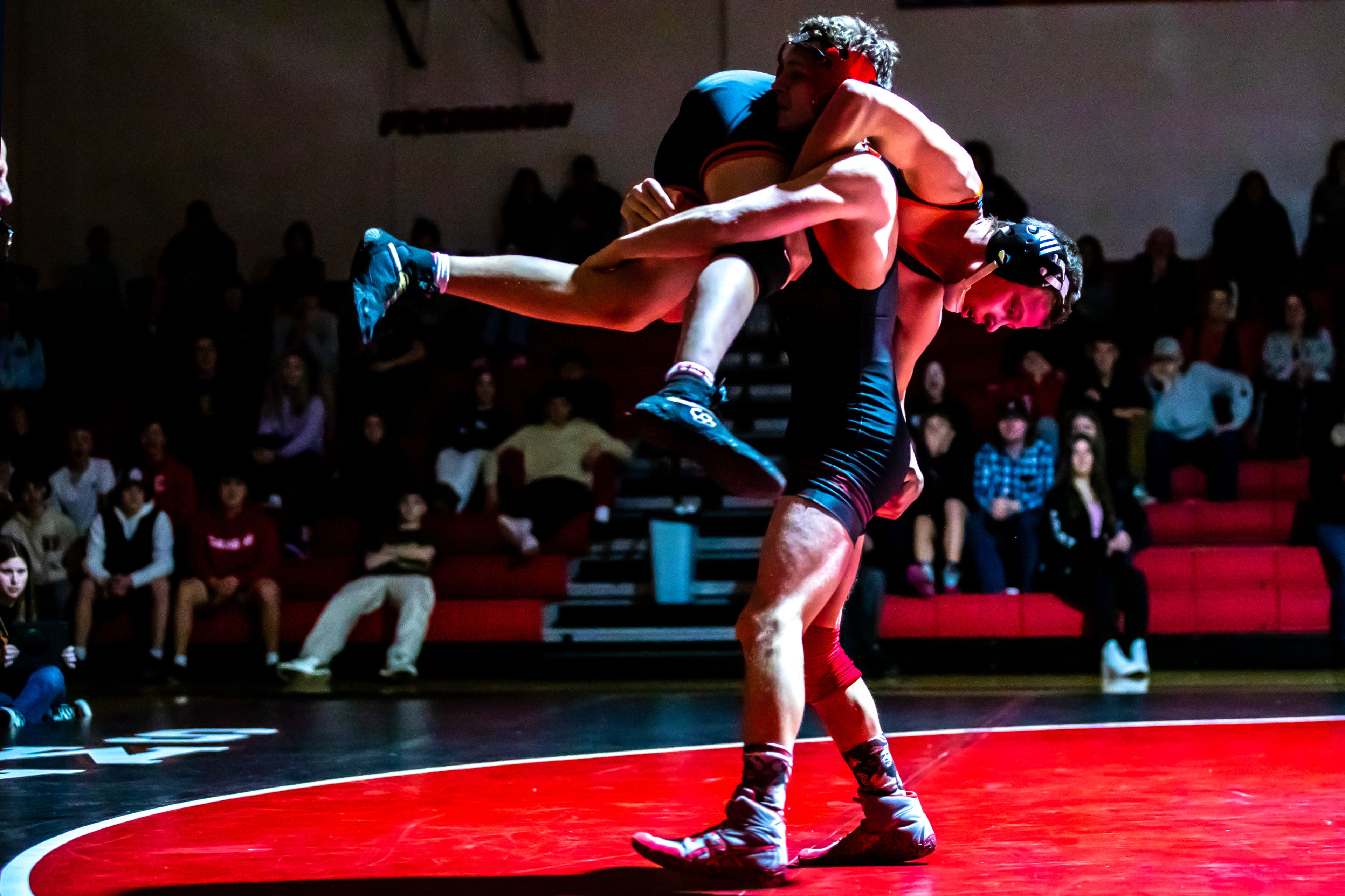 Clarkston’s Gabe Weza picks up West Valley’s Kartyr Schroeder in the 132 pound weight class match during a wrestling duel Wednesday at Clarkston.