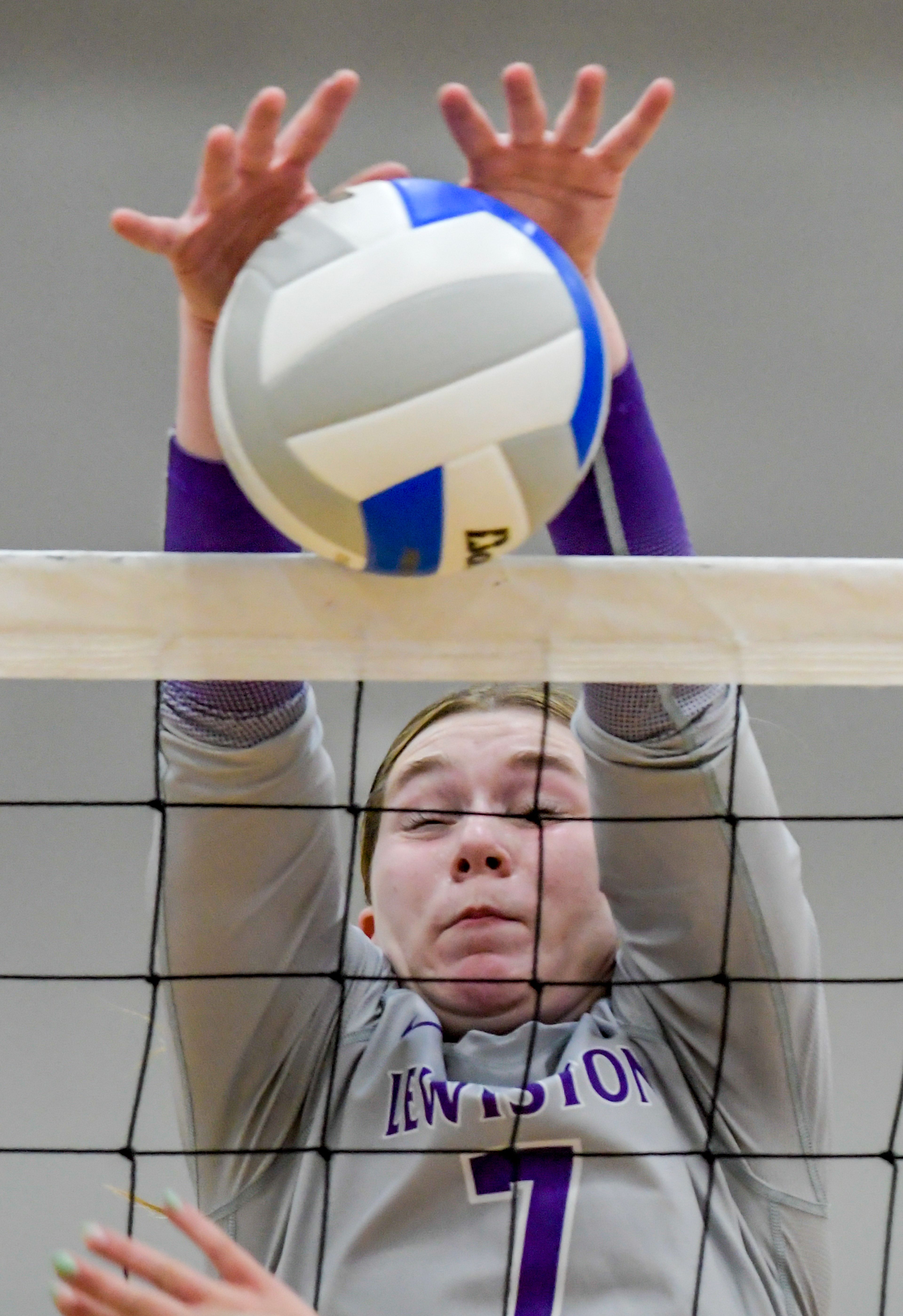 Lewiston outside hitter Avery Blamer blocks a Sandpoint hit across the net during a volleyball game Thursday in Lewiston.,