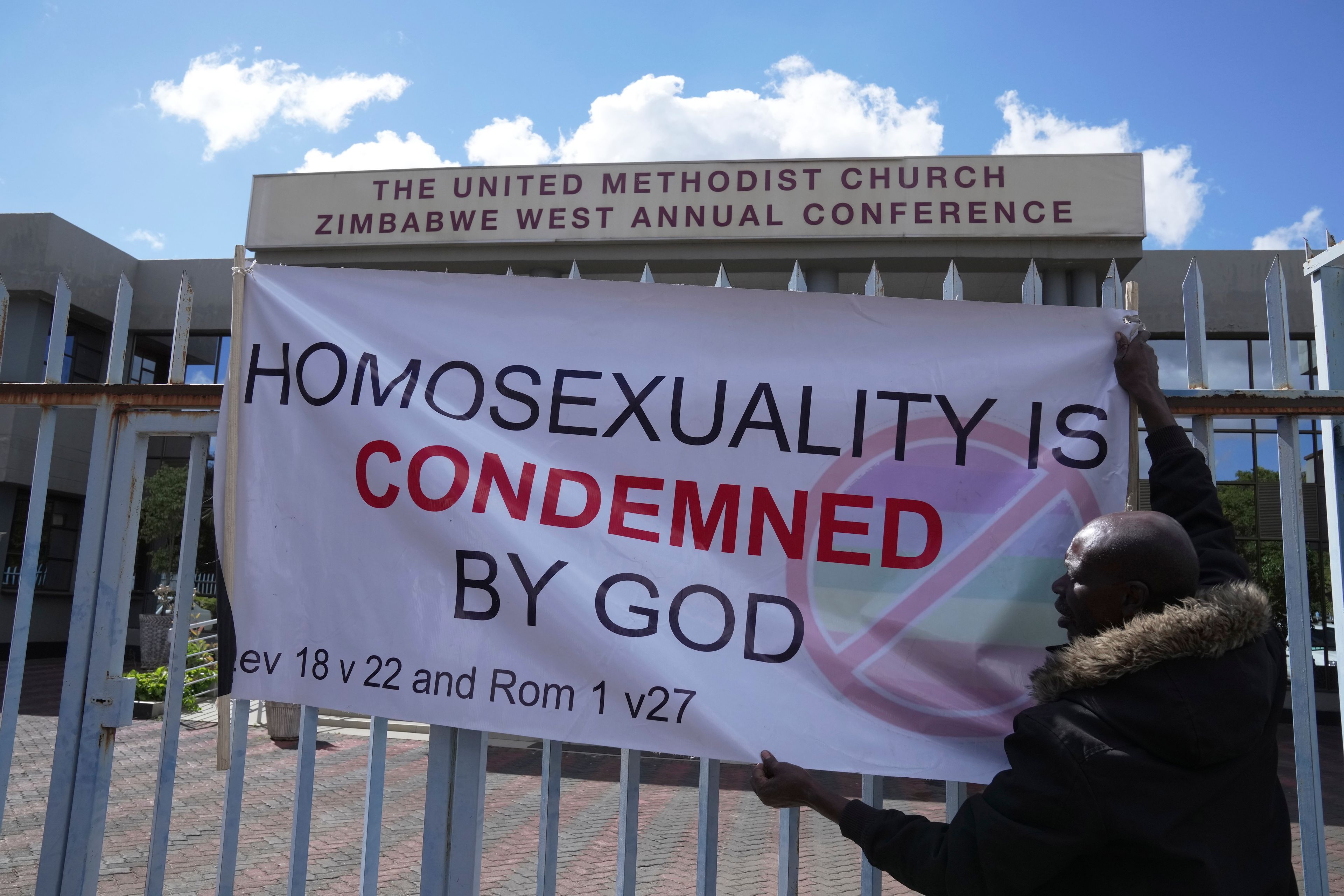 A member the United Methodist Church in Zimbabwe displays a placard while holding a protest at the church premises in Harare, Thursday, May 30, 2024. The protests denouncing homosexuality and the departure of the church from the scriptures and doctrine, come barely a month after the United Methodist Church Worldwide General Conference held in North Carolina, US repealed their church's longstanding ban on LGBTQ clergy, removing a rule forbidding "self-avowed practising homosexuals" from being ordained or appointed as ministers.