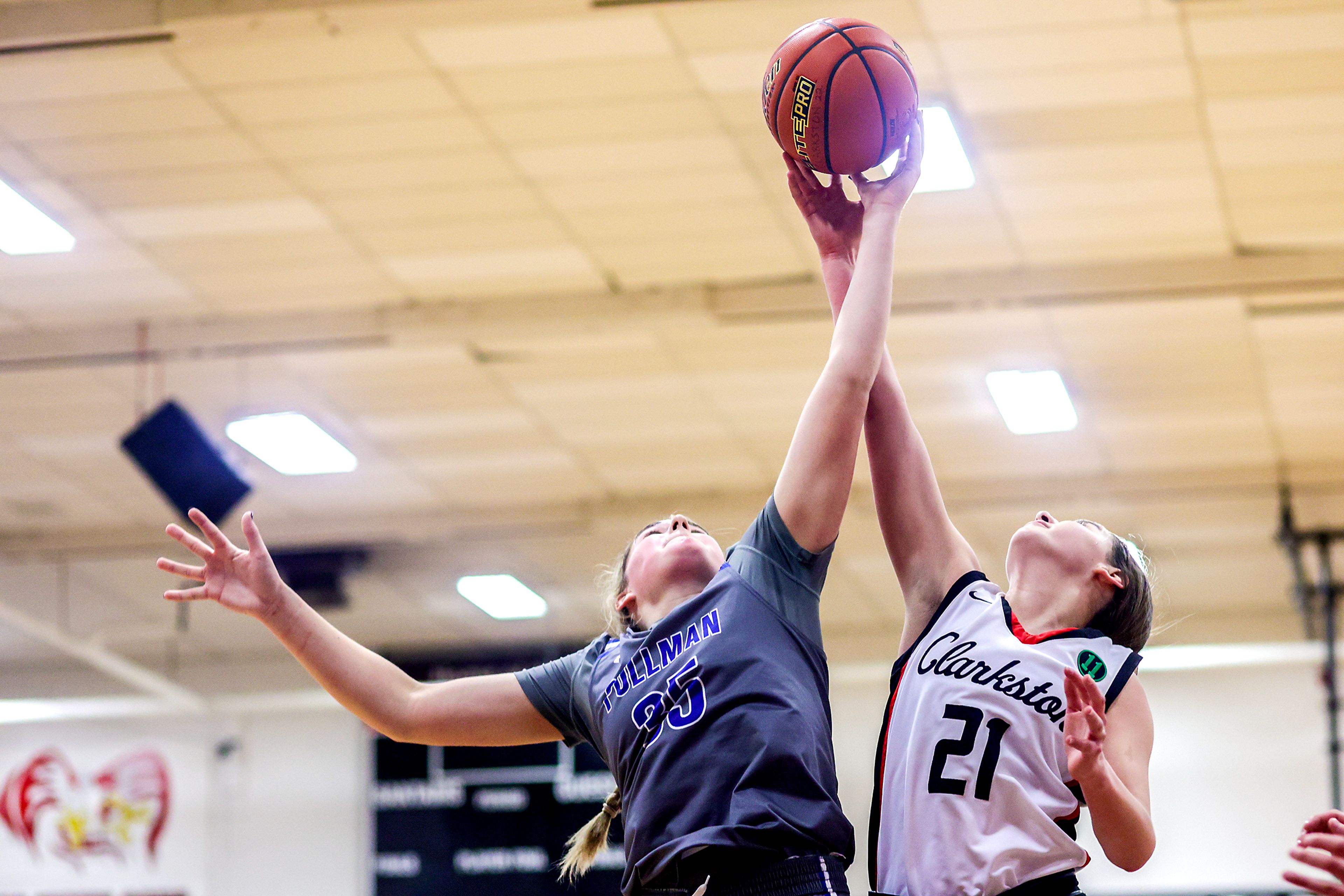 Pullman post Ryliann Bednar, left, and Clarkston wing Ella Leavitt compete for a rebound during Tuesday’s Class 2A Greater Spokane League girls basketball game.