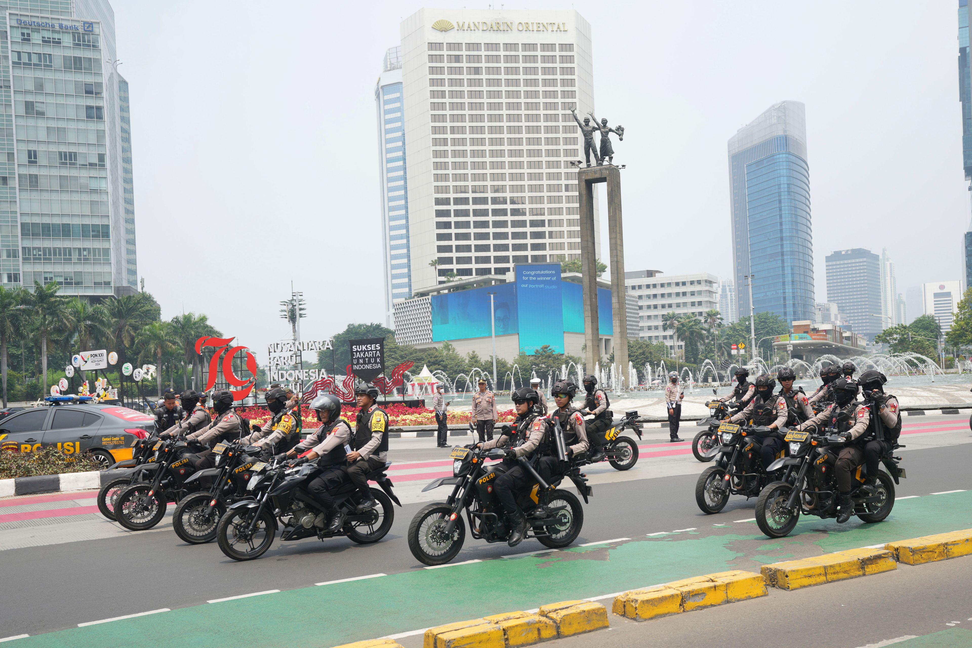 Police on motorcycles patrol on the street in Jakarta, Indonesia, Tuesday, Sept. 3, 2024.