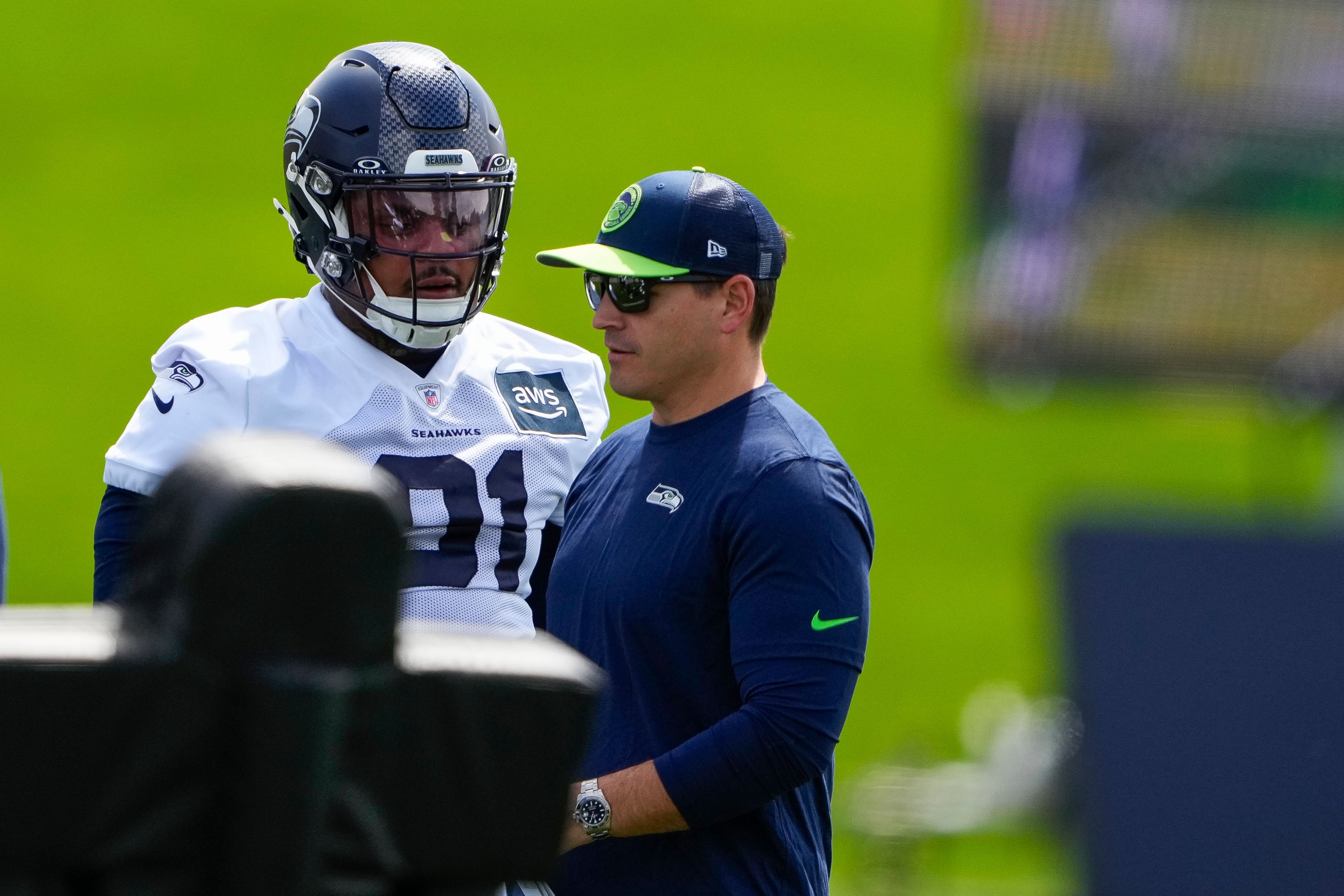 Seahawks defensive tackle Byron Murphy II talks with coach Mike Macdonald during the team's rookie minicamp Friday in Renton, Wash.