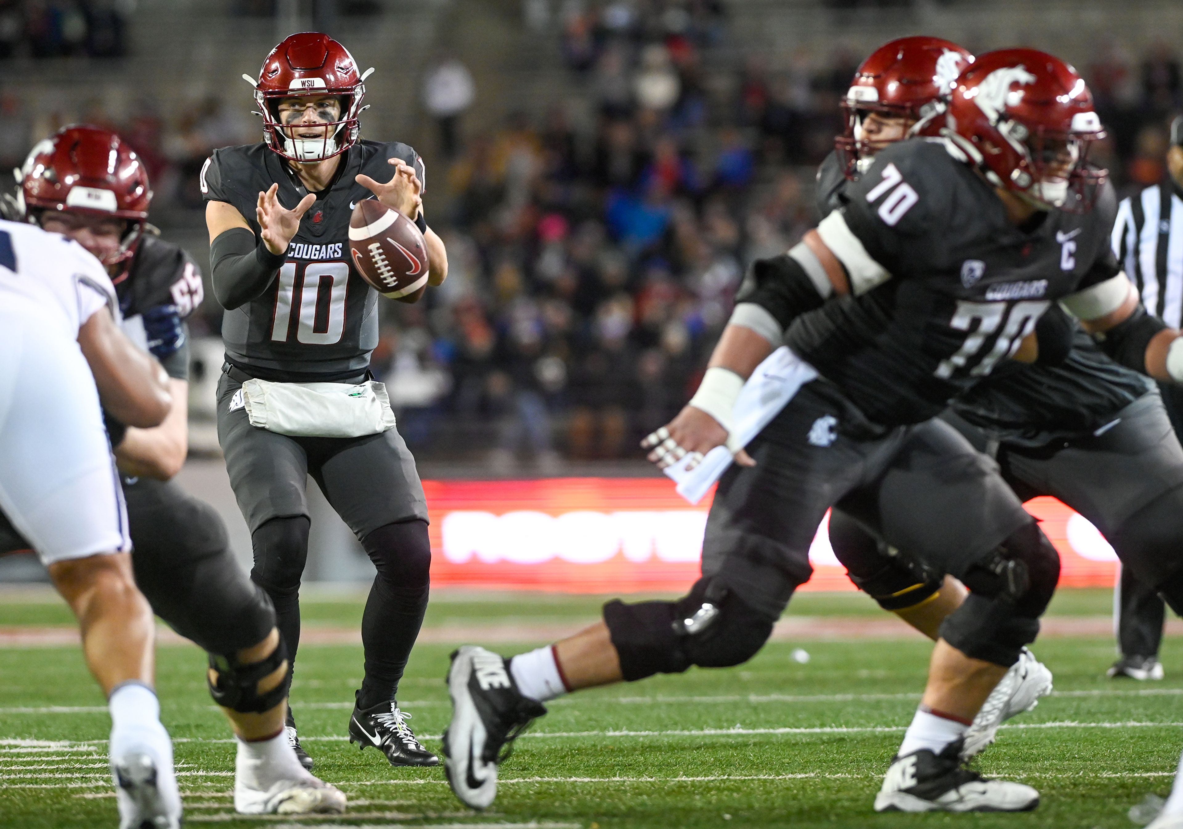 Washington State quarterback John Mateer (10) catches the ball at the start of a play against Utah State Saturday at Gesa Field in Pullman.