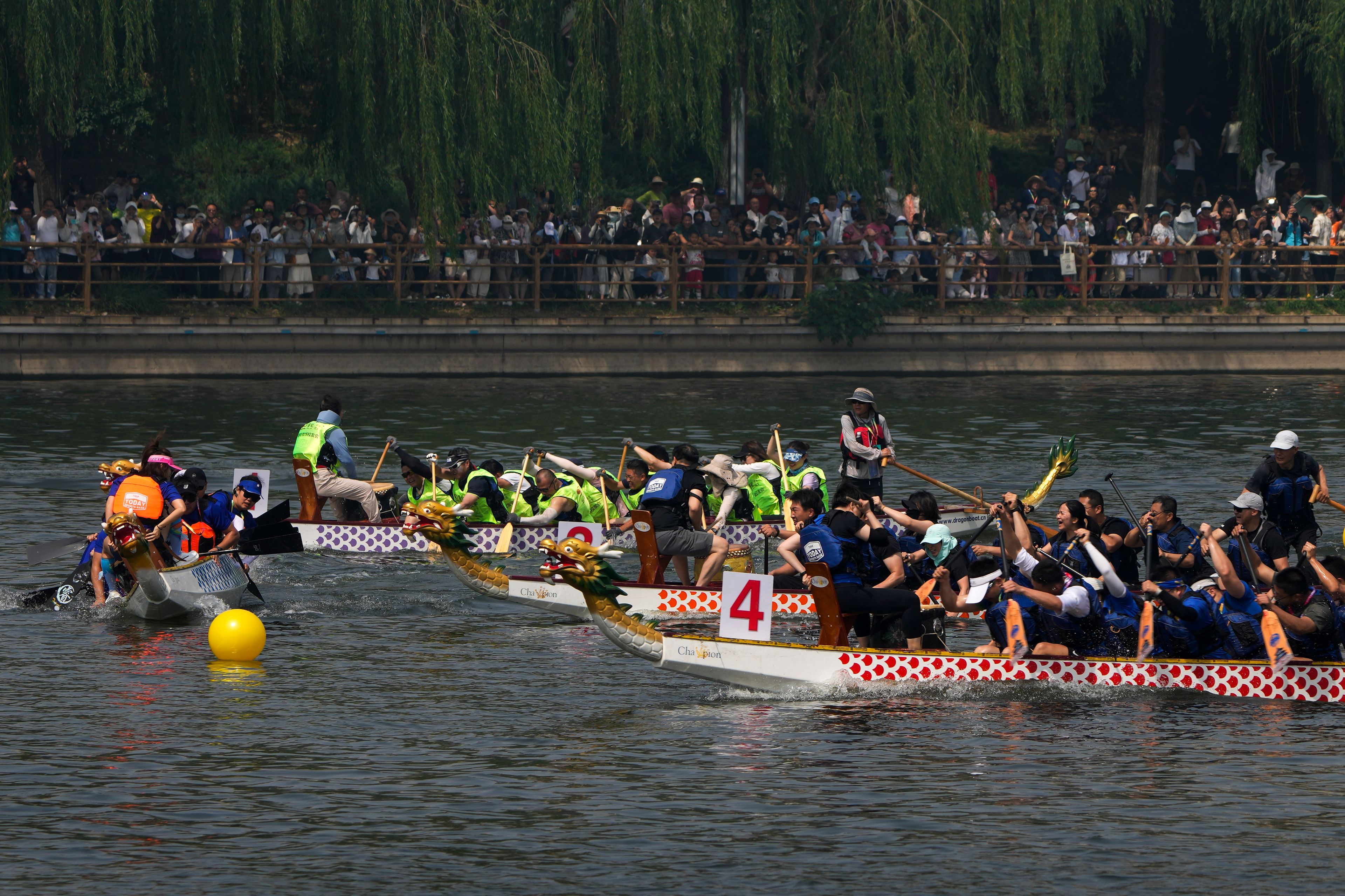 Competitors take part in a race during the Dragon Boat Festival at a canal in Tongzhou, outskirts of Beijing, Monday, June 10, 2024. The Duanwu Festival, also known as the Dragon Boat Festival, falls on the fifth day of the fifth month of the Chinese lunar calendar and is marked by eating rice dumplings and racing dragon boats.