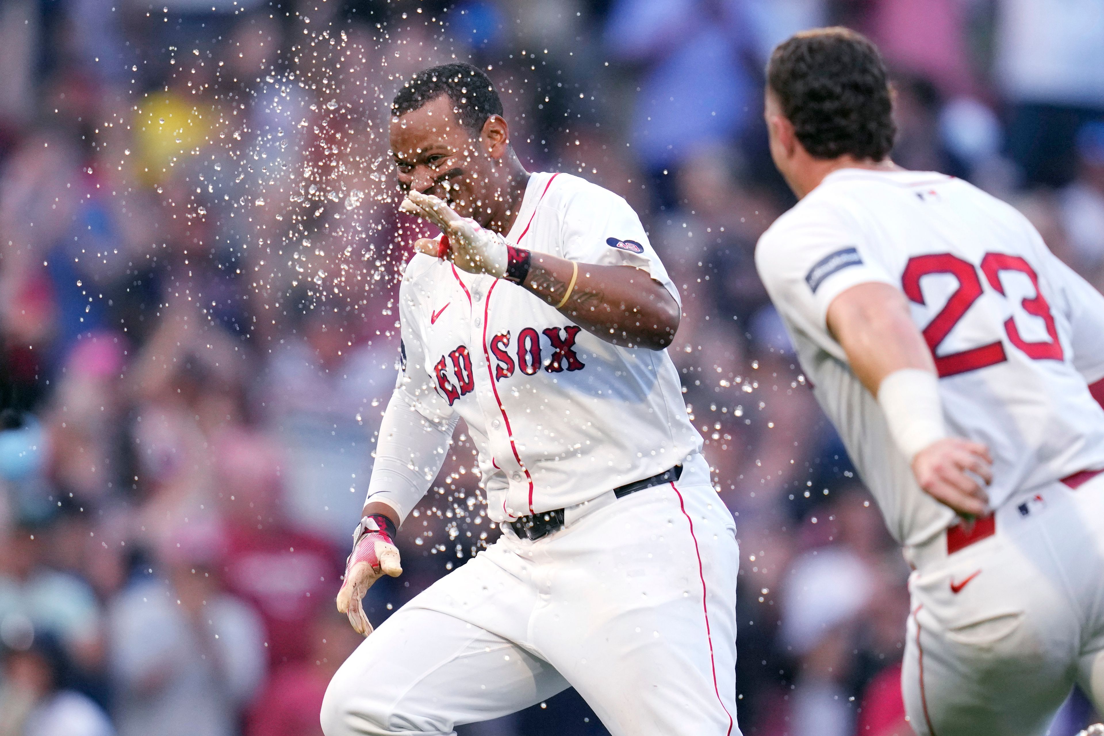 Boston Red Sox's Rafael Devers, left, celebrates after his game-winning RBI double, which drove in Tyler O'Neill, during the 10th inning of a baseball game against the Seattle Mariners, Wednesday, July 31, 2024, in Boston. At right is Boston Red Sox shortstop Romy Gonzalez. (AP Photo/Charles Krupa)