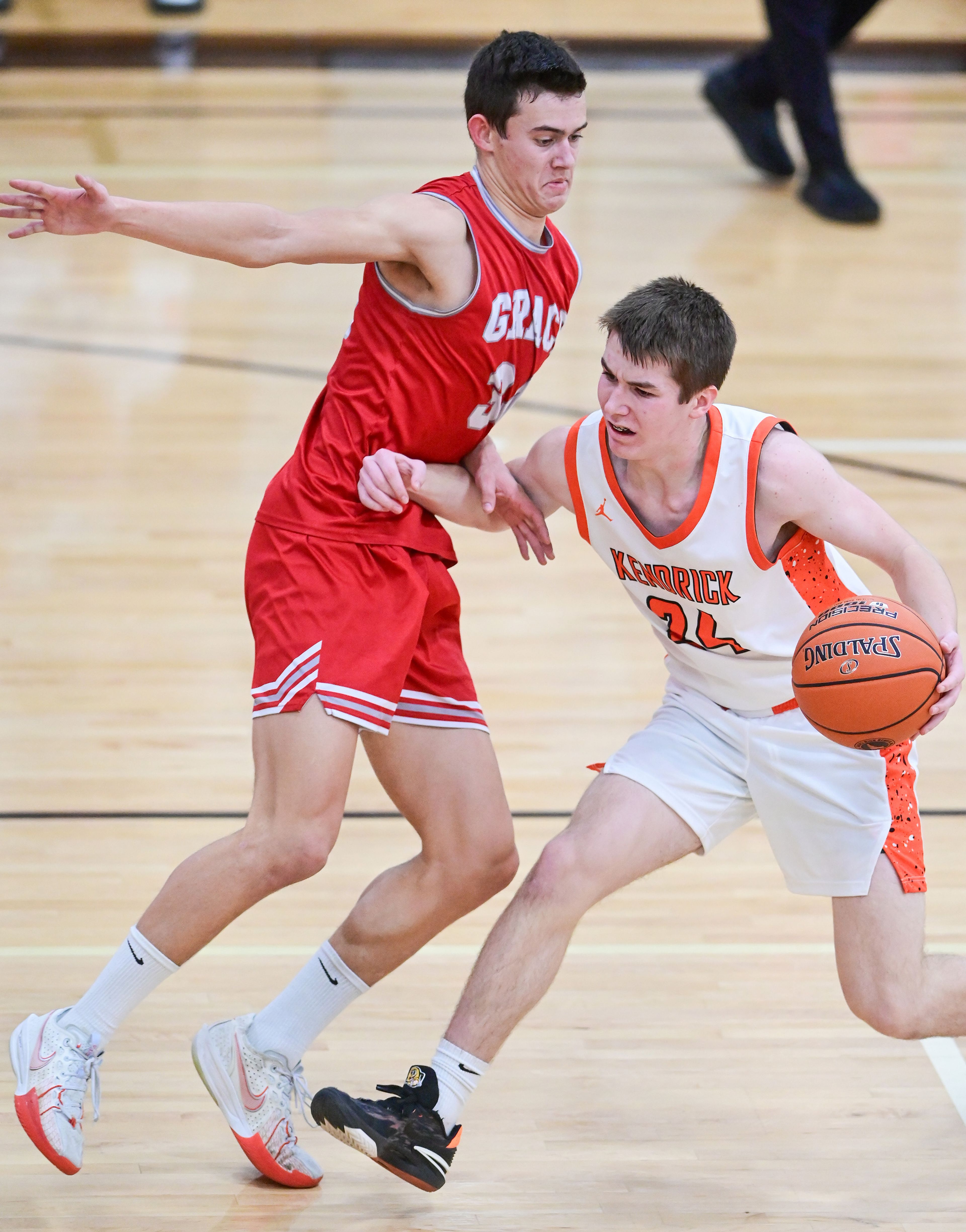 Kendrick's Hudson Kirkland pushes past Grace’s Parker Yost at the Idaho 2A state tournament on Friday in Caldwell, Idaho.
