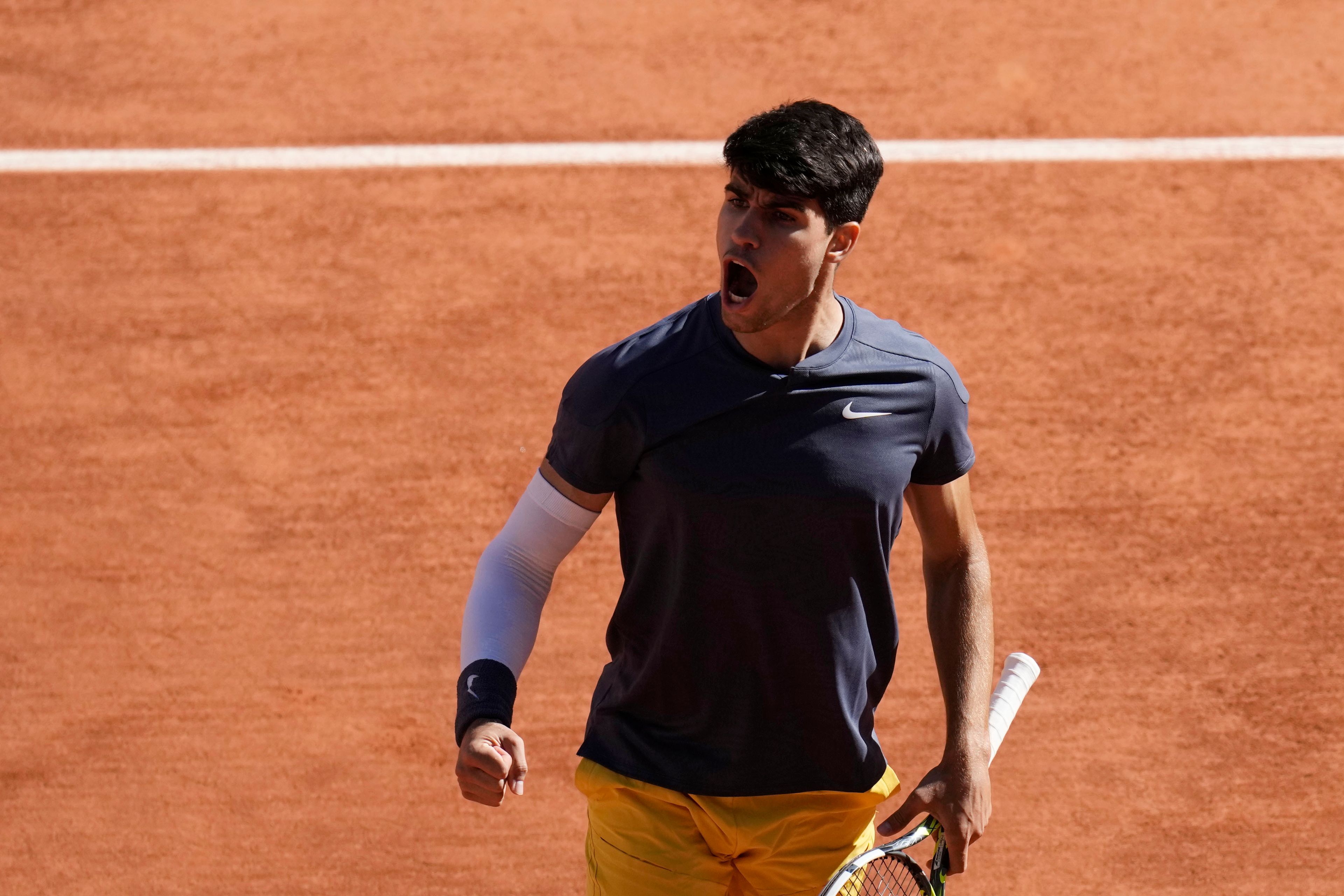 Spain's Carlos Alcaraz reacts during his semifinal match of the French Open tennis tournament against Italy's Jannik Sinner at the Roland Garros stadium in Paris, Friday, June 7, 2024.