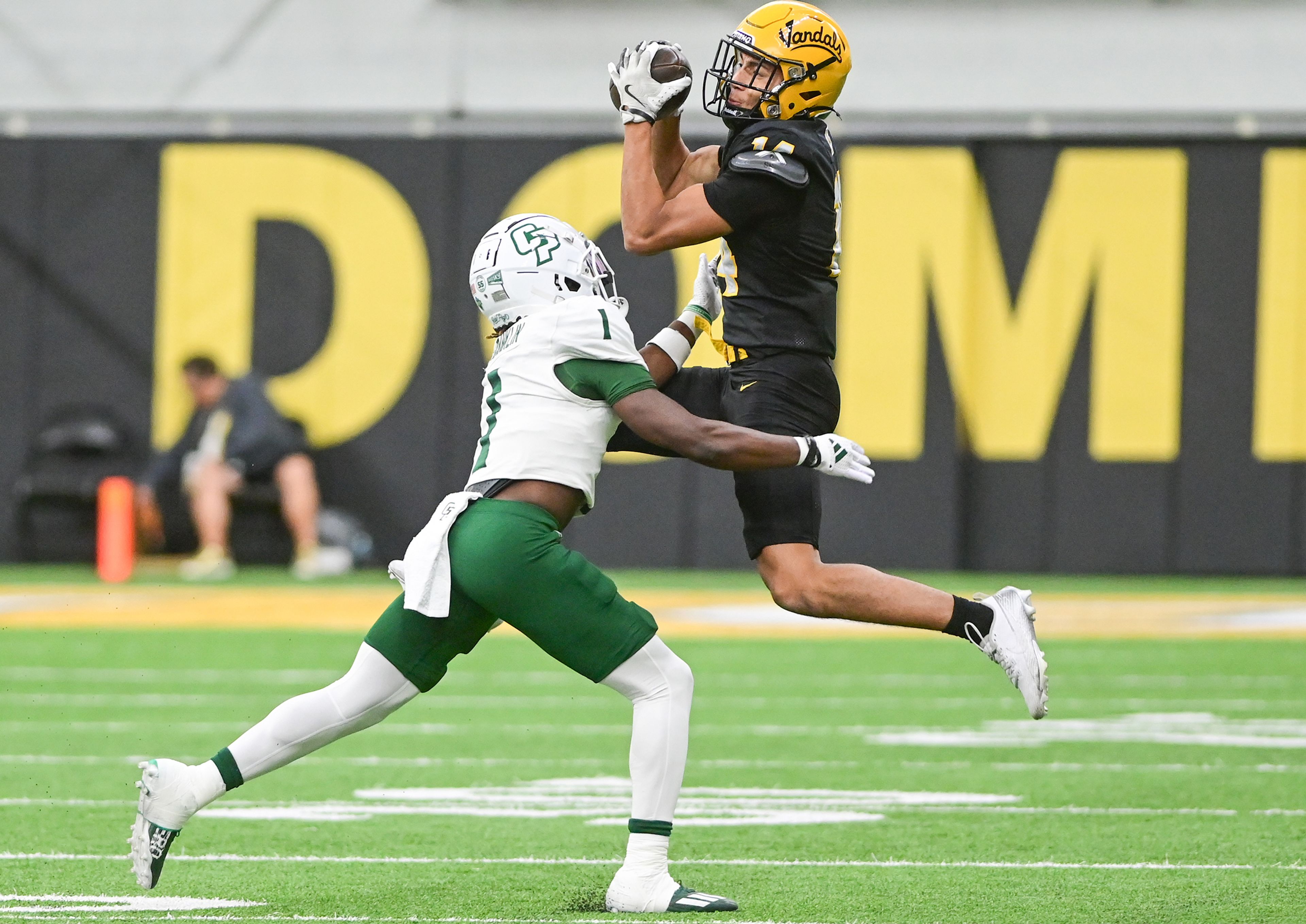 Idaho wide receiver Emmerson Cortez-Menjivar jumps to catch the ball with pressure from Cal Poly cornerback Delano Franklin Saturday at the P1FCU Kibbie Dome in Moscow.,