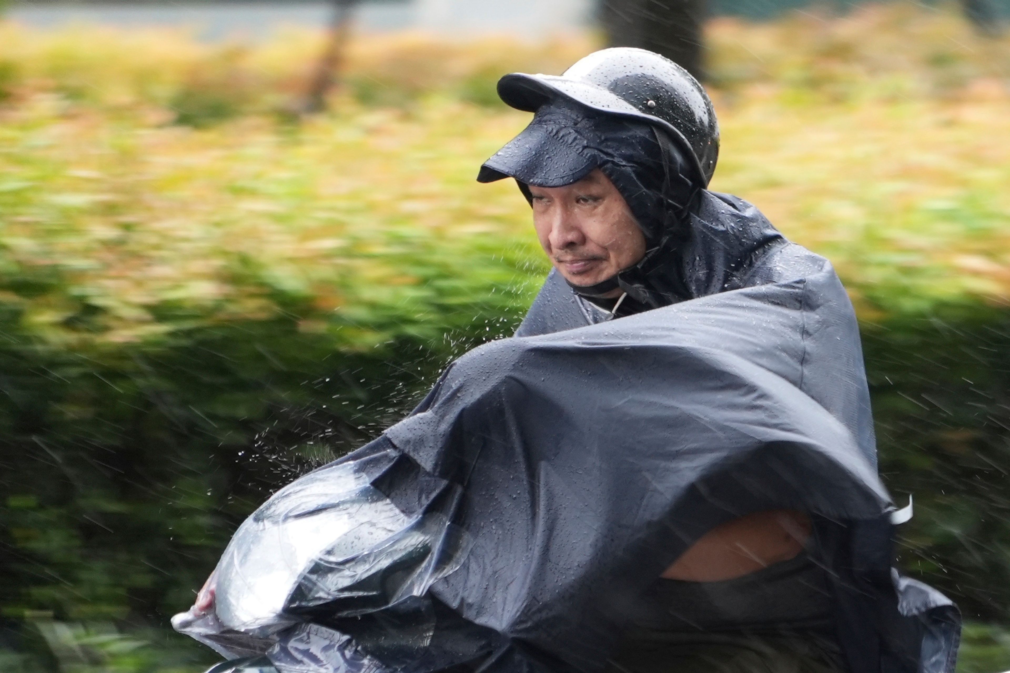 A man rides a motorcycle in the rain caused by typhoon Yagi in Hanoi, Vietnam Saturday, Sept. 7, 2024.