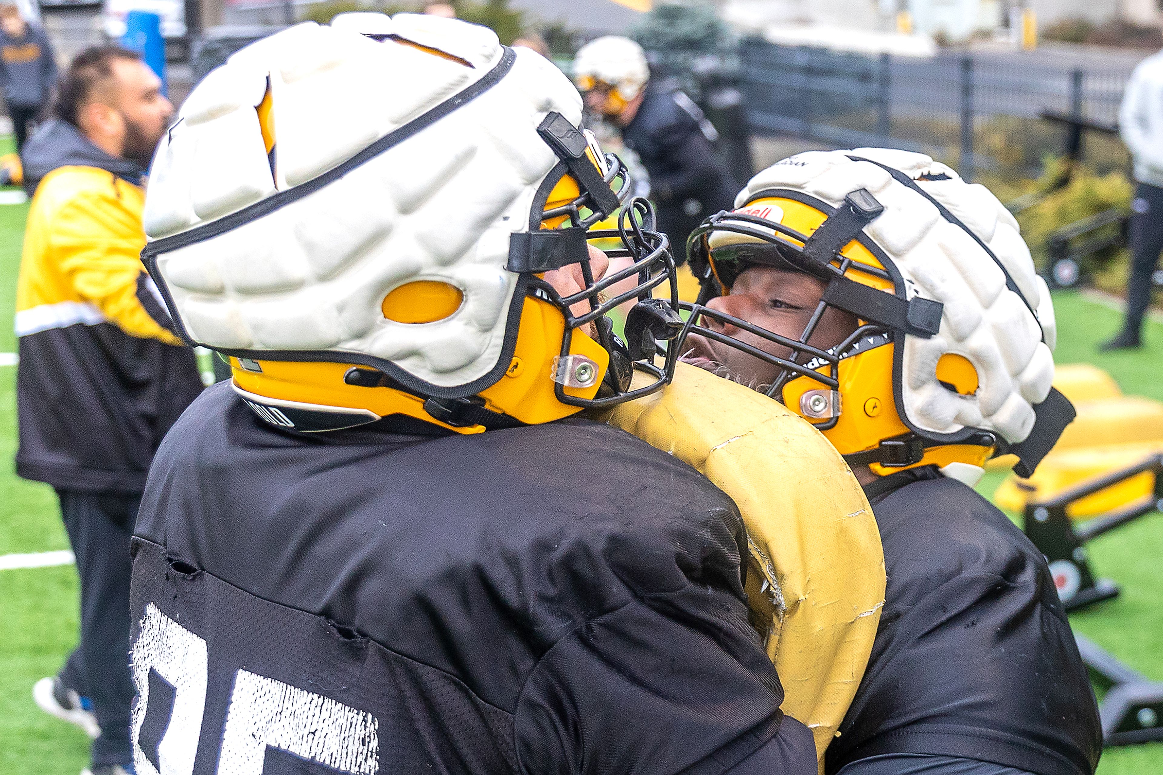 Defensive lineman Jahkari Larmond runs into a pad held by his teammate during Idaho’s first spring practice in Moscow.