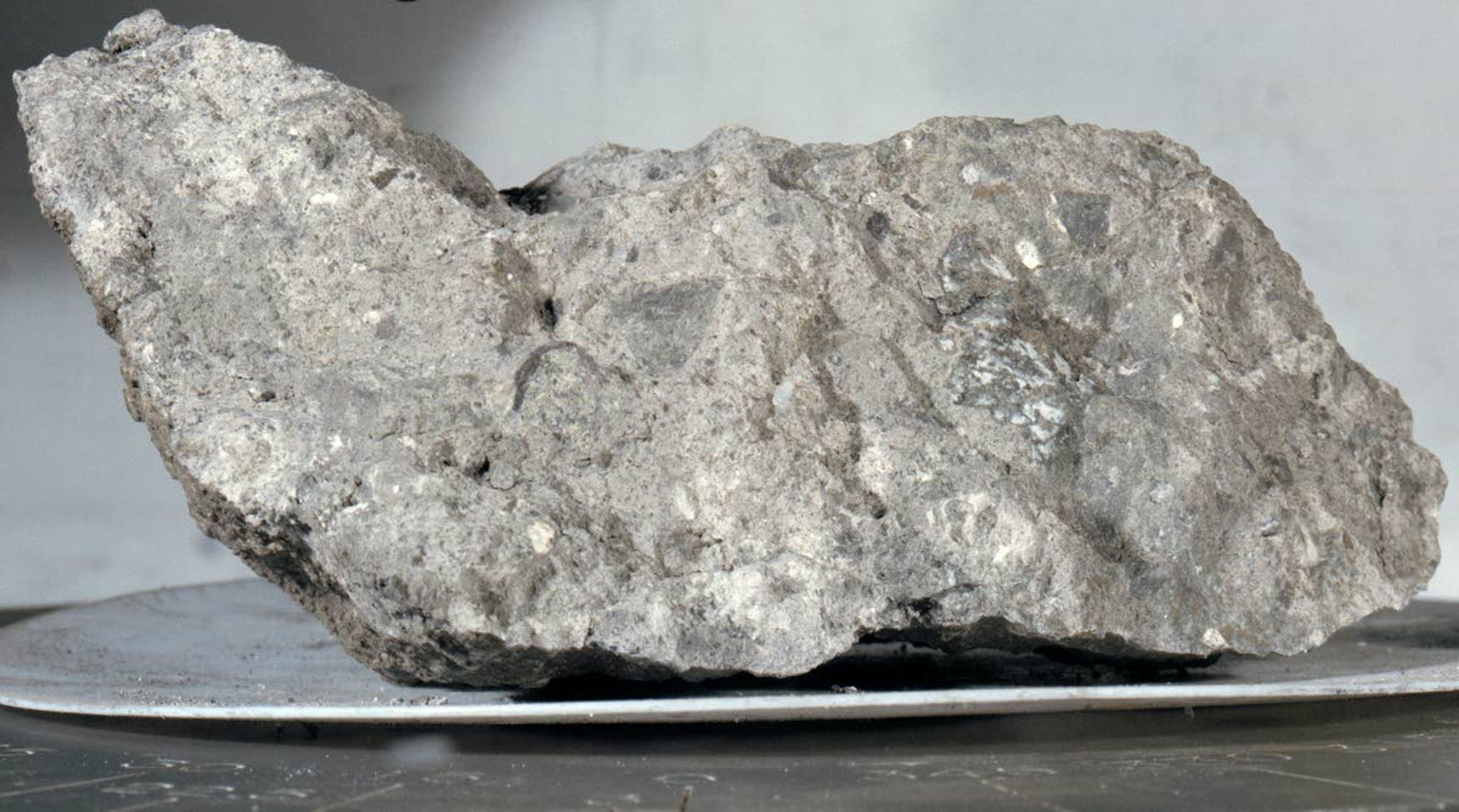 Some of the rock samples collected during the Apollo 11 mission were lunar breccias. Like the one pictured here, they're formed during meteor strikes; the impact breaks the surface rocks into fragments, which are then cemented back together.