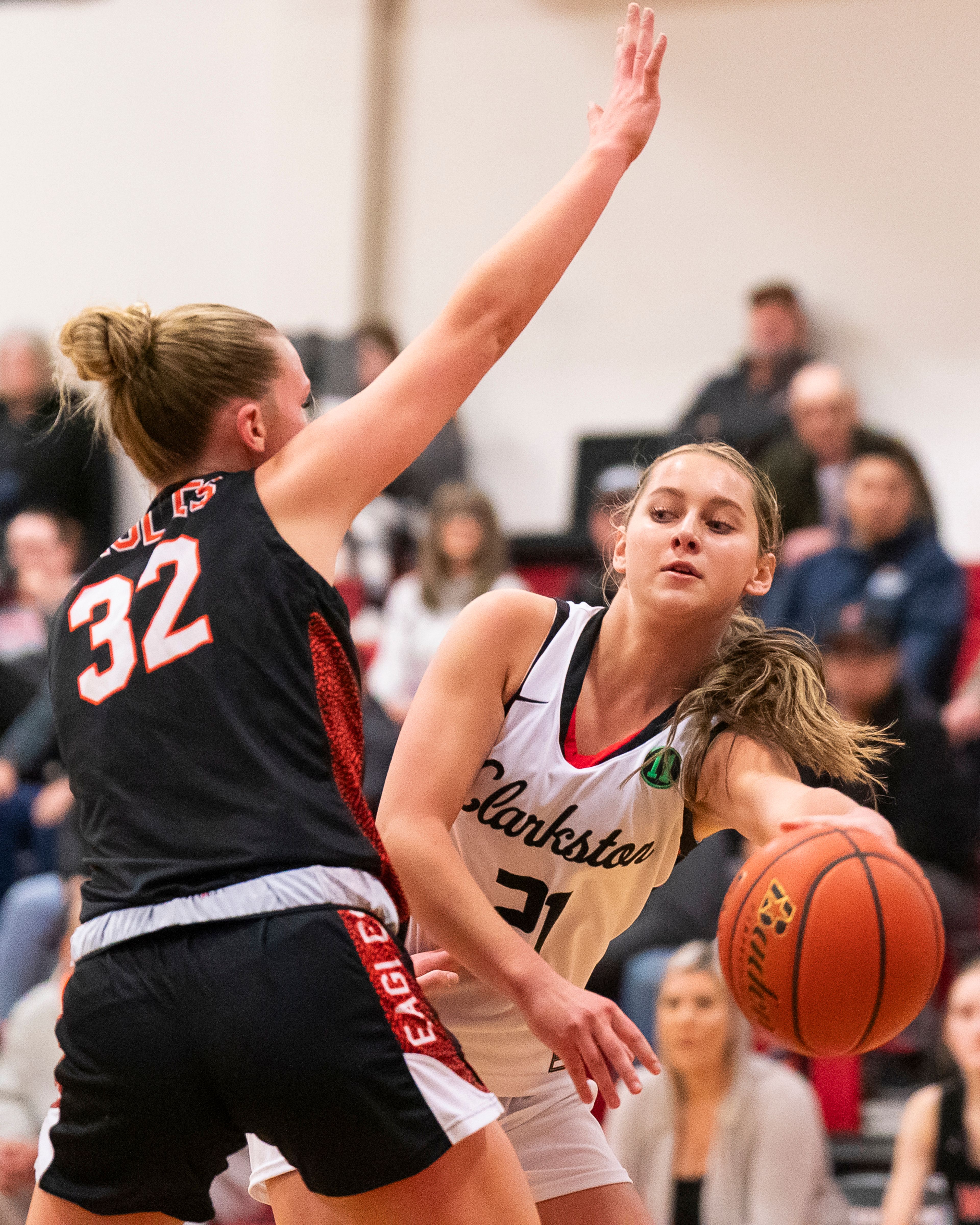 Clarkston’s Ella Leavitt, right, passes the ball while West Valley's Macy Osborn, left, defends during a game Tuesday at Kramer Gym in Clarkston.