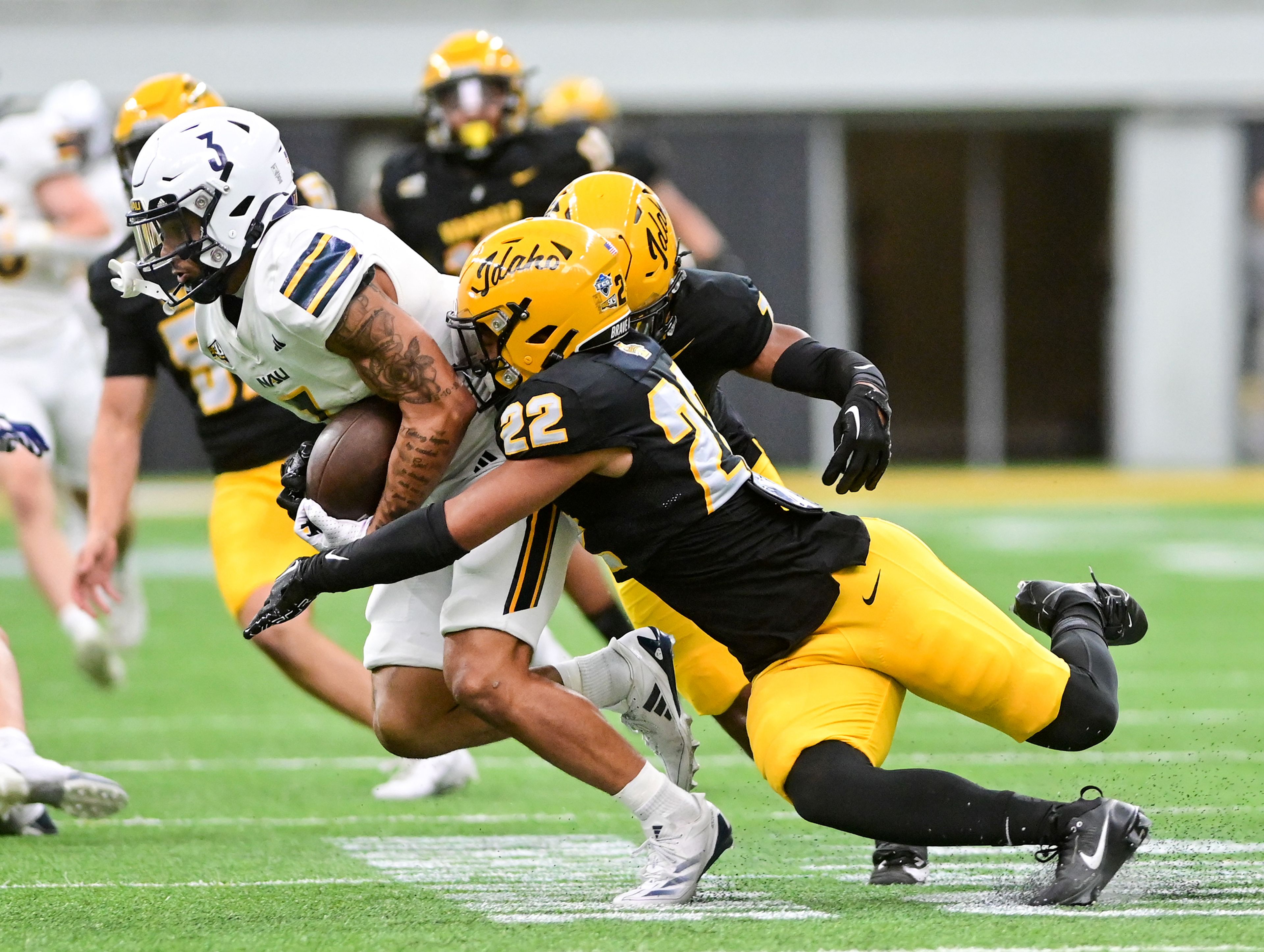 Idaho defensive back Dwayne McDougle tackles Northern Arizona wide receiver Isaiah Eastman Saturday at the P1FCU Kibbie Dome in Moscow.,